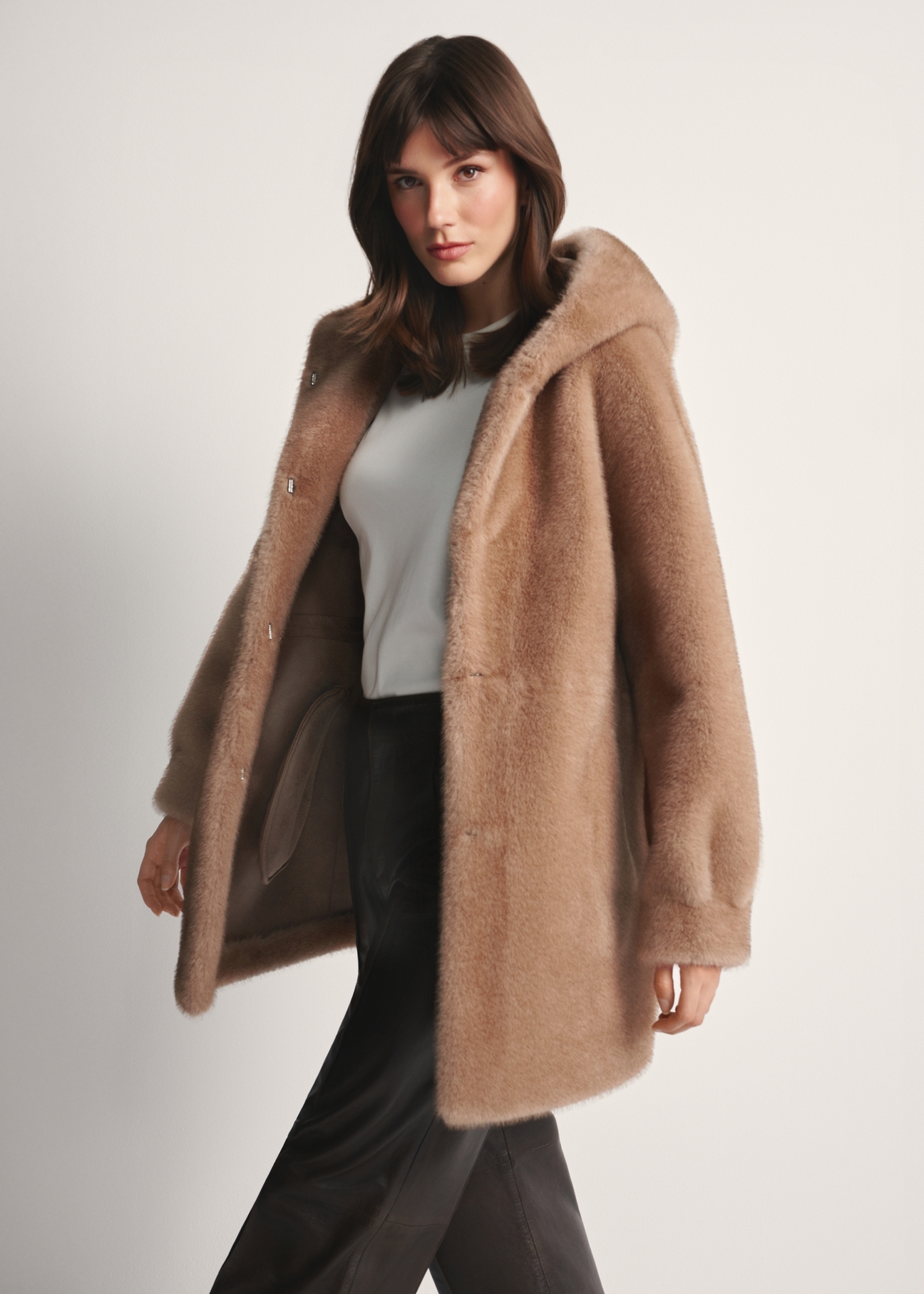 Women's beige fur coat with hood FUTDP-0062-81(Z25), front view of the product on the model. Half of the silhouette visible.