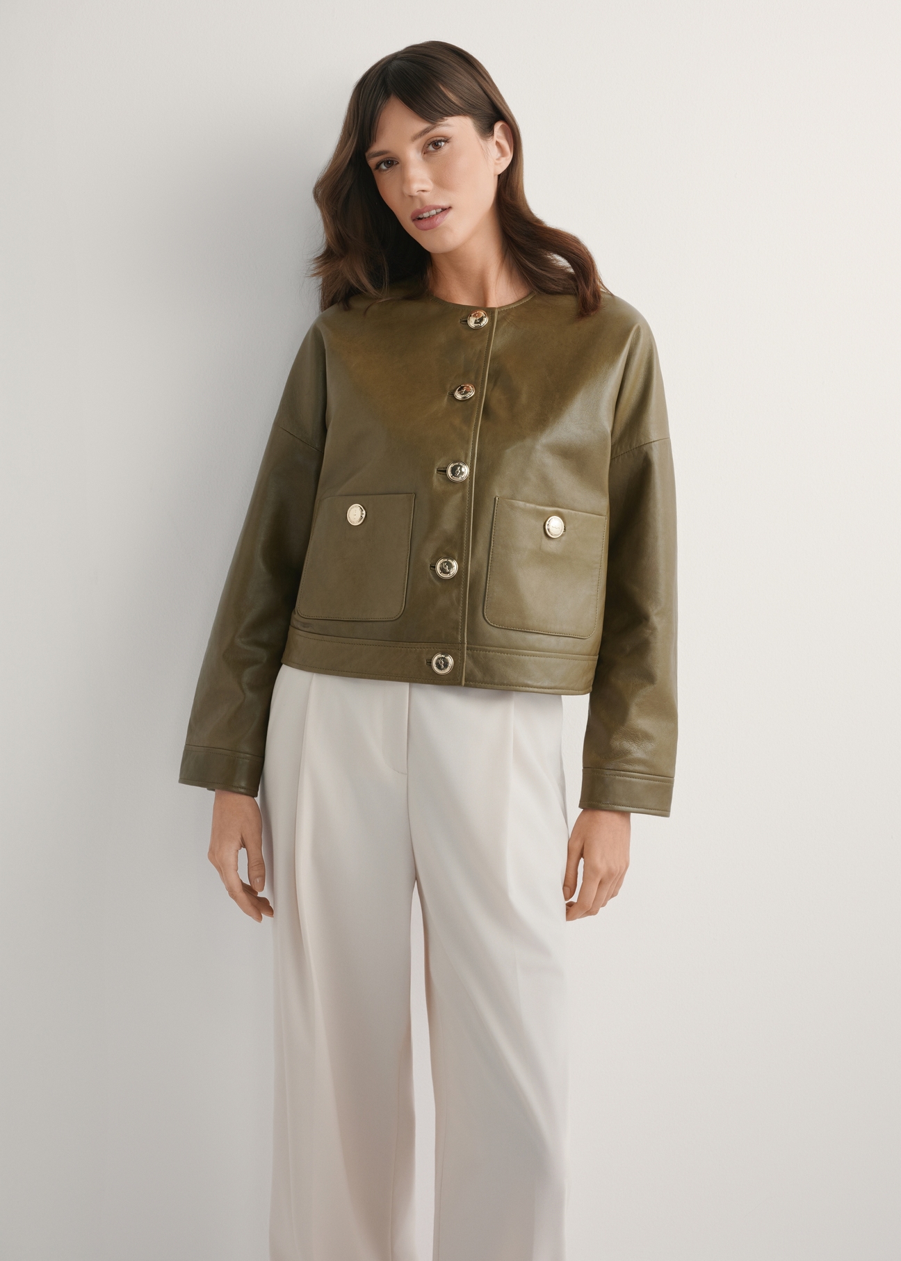 Women's Khaki Short Leather Jacket KURDS-0590-8D(W26), front view of the product on the model. Half of the silhouette visible.