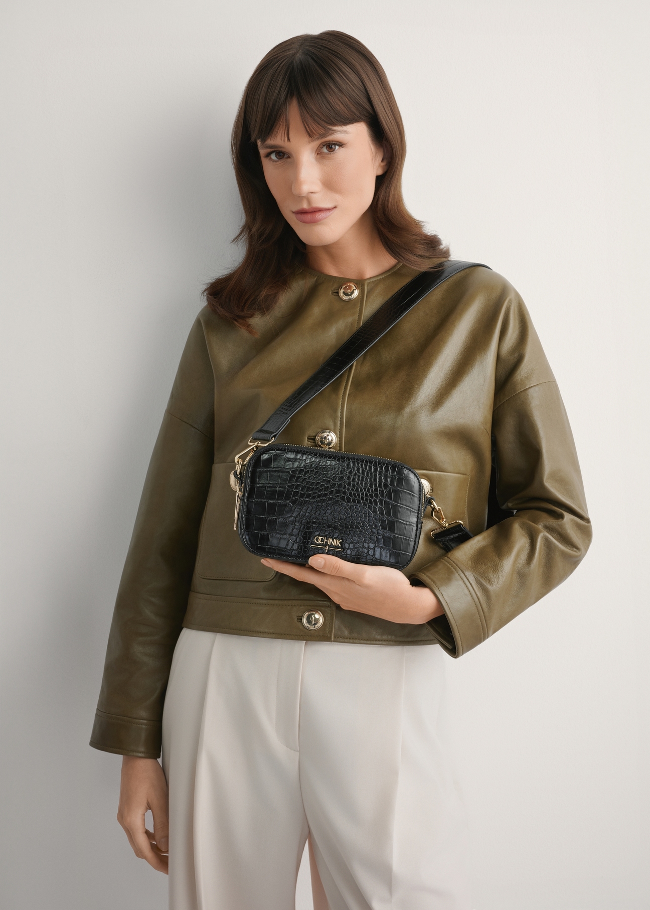 Black small women's croco handbag TOREC-1172-9G(W26), front product view on the model's silhouette.