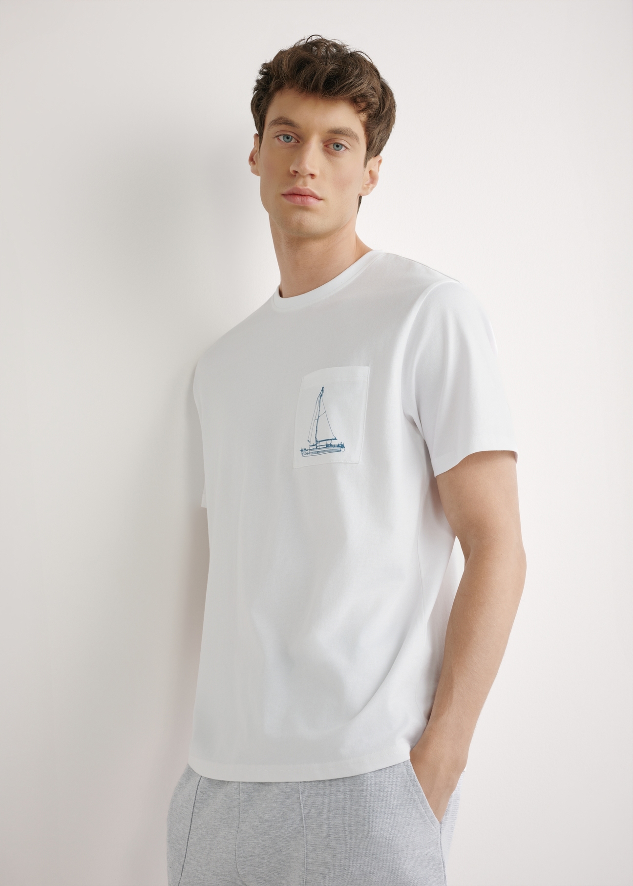 Men's white T-shirt with print TSHMT-0145-0A(W26), front view of the product on the model. Half of the silhouette visible.