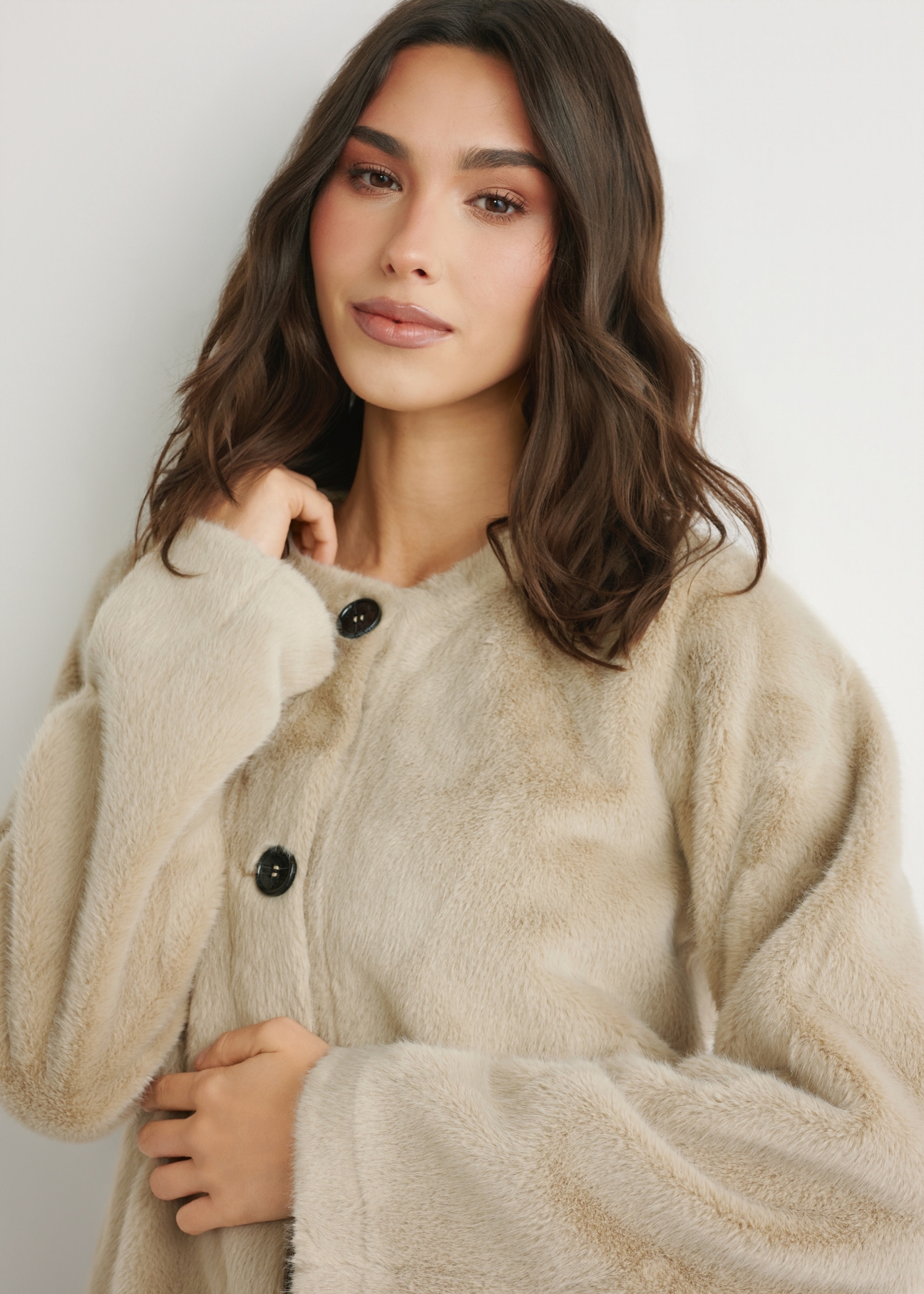 Women's short beige fur coat FUTDP-0079-1A(W26), front view of the product on the model. Half of the silhouette visible.