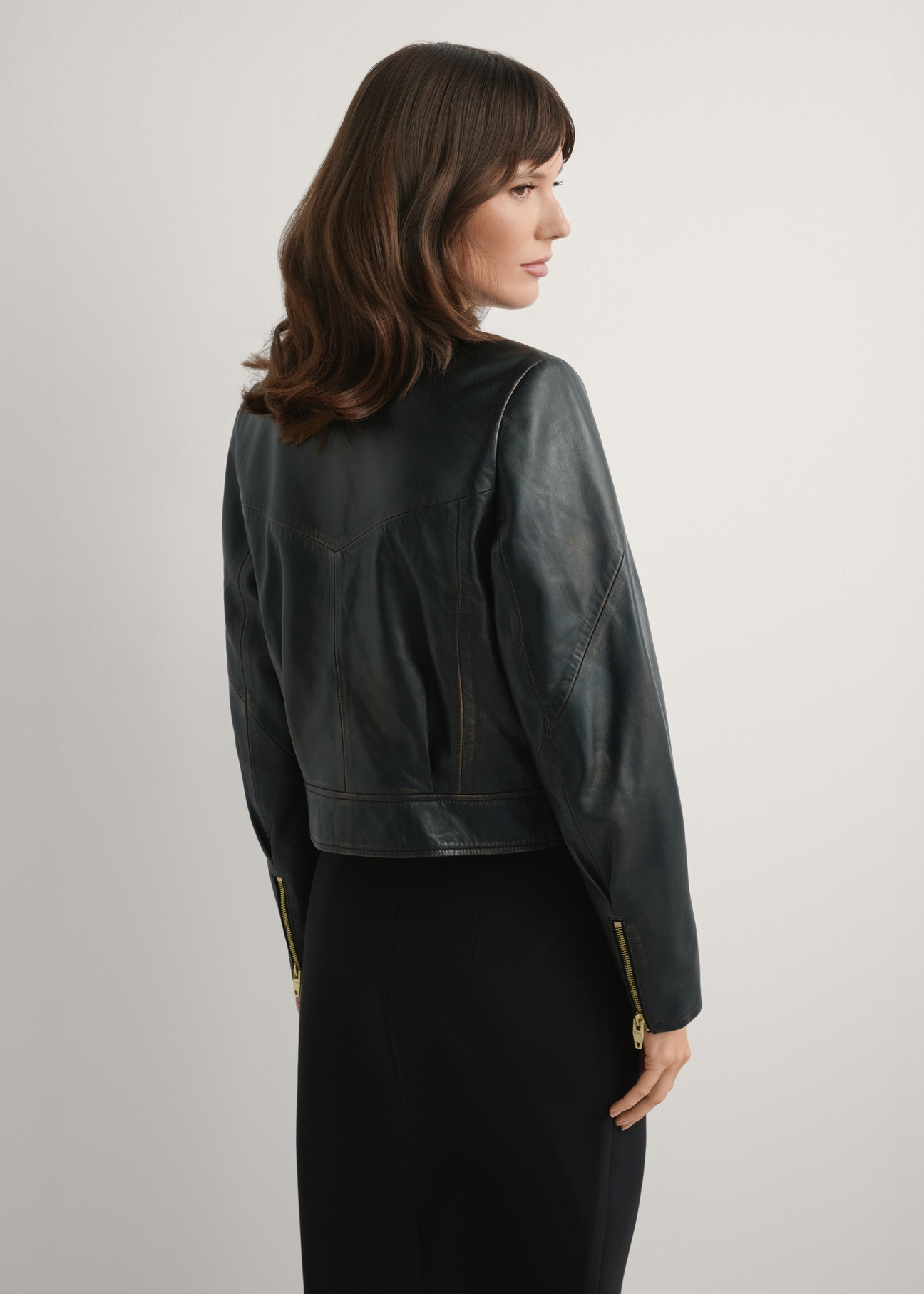 Women's vintage short leather jacket KURDS-0573-9J(W26), product view from the back on the model. Half of the silhouette visible.