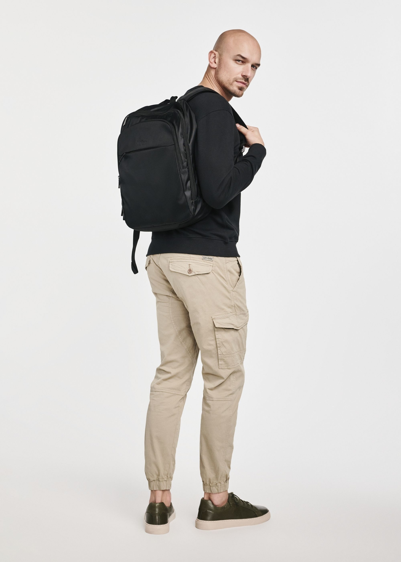 Men's black backpack with laptop compartment TORMN-0264C-99(Z25), product view on model. Full body visible.