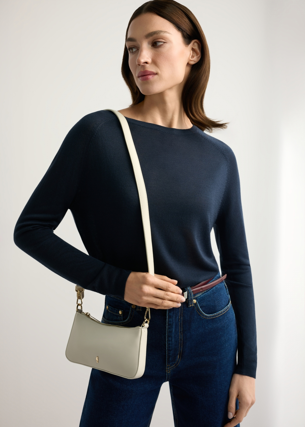 Small cream women's handbag TOREC-1188-0B(W26) - front view of the product, on a model, against a light background. Half-length silhouette visible.
