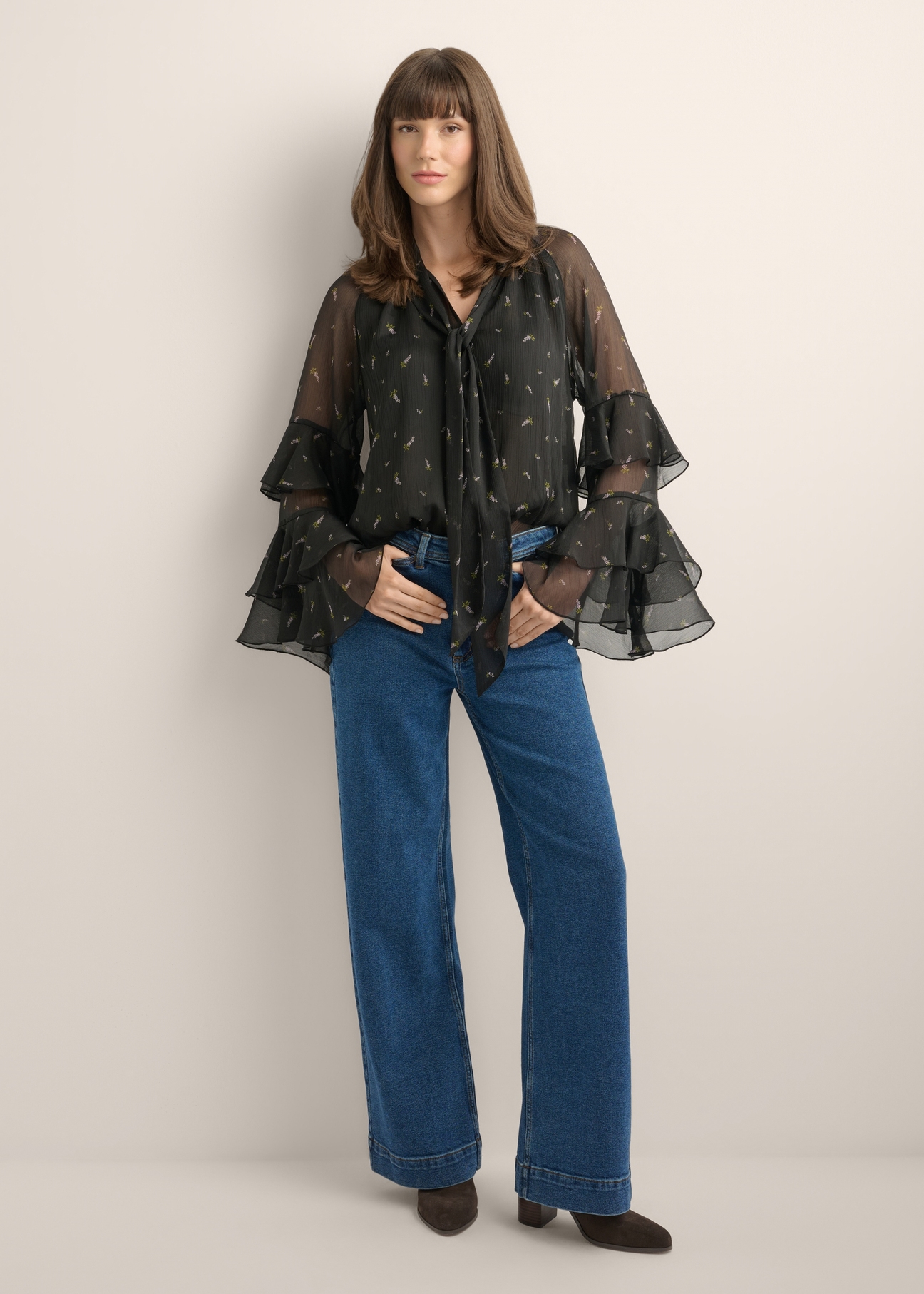 Women's black blouse with a lilac pattern BLUDT-0212-9P(Z26), front view of the product on the model. Full body visible.
