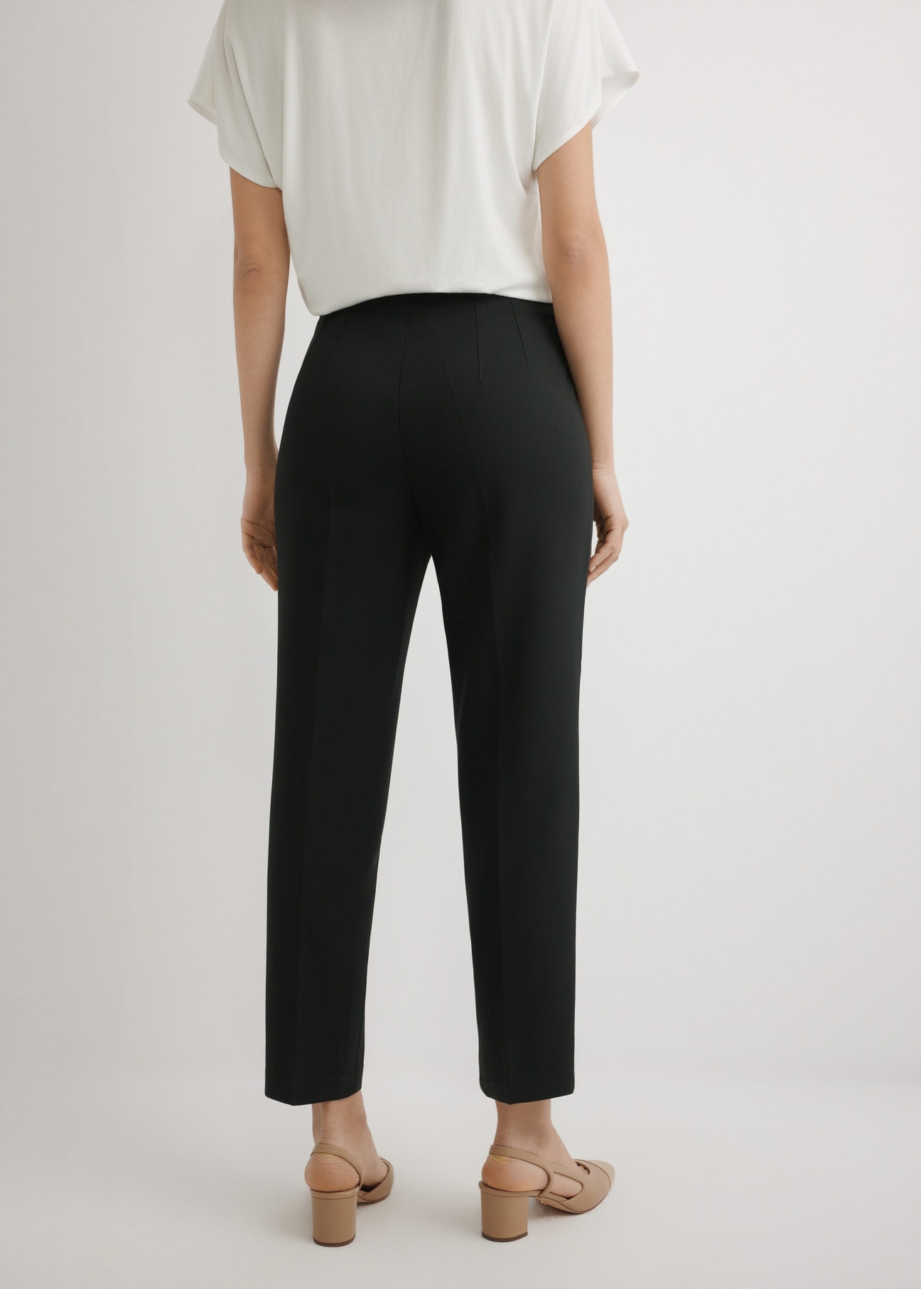 Black elegant women's trousers SPODT-0109-99(W26), back view of the product on the model. Half of the silhouette visible.