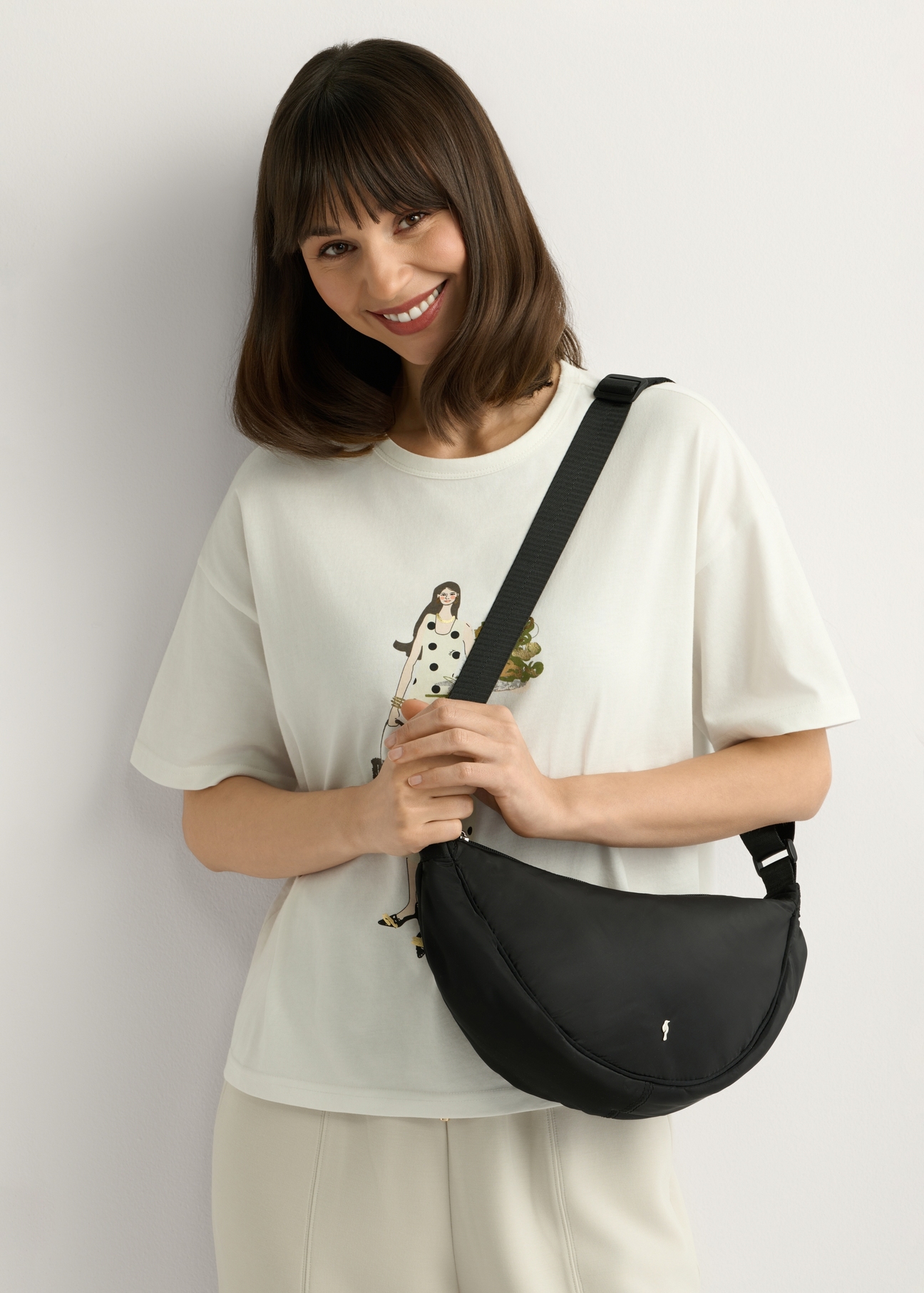 Black nylon women's handbag TOREN-0342-99(W26) - front view of the product, on a model, on a white background.