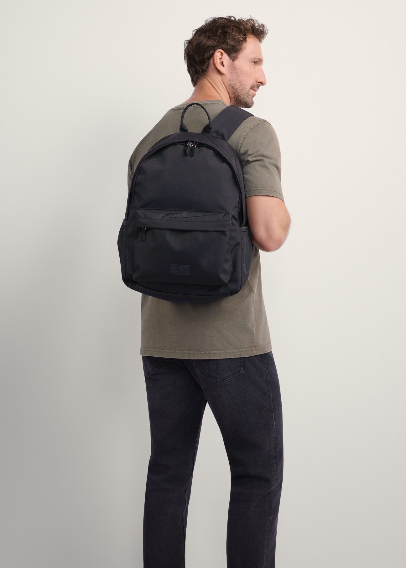 Black men's backpack TORMN-0383-99(Z25), product view on model. Half silhouette visible.