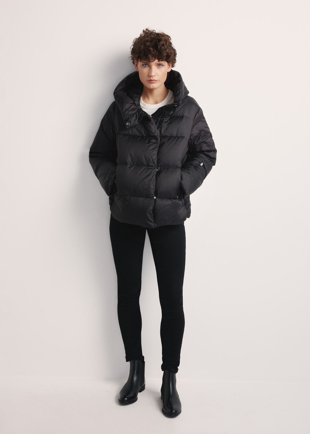 Black women's down jacket KURDT-0585-99(Z25), product visible from the front on the model, the entire silhouette is visible.