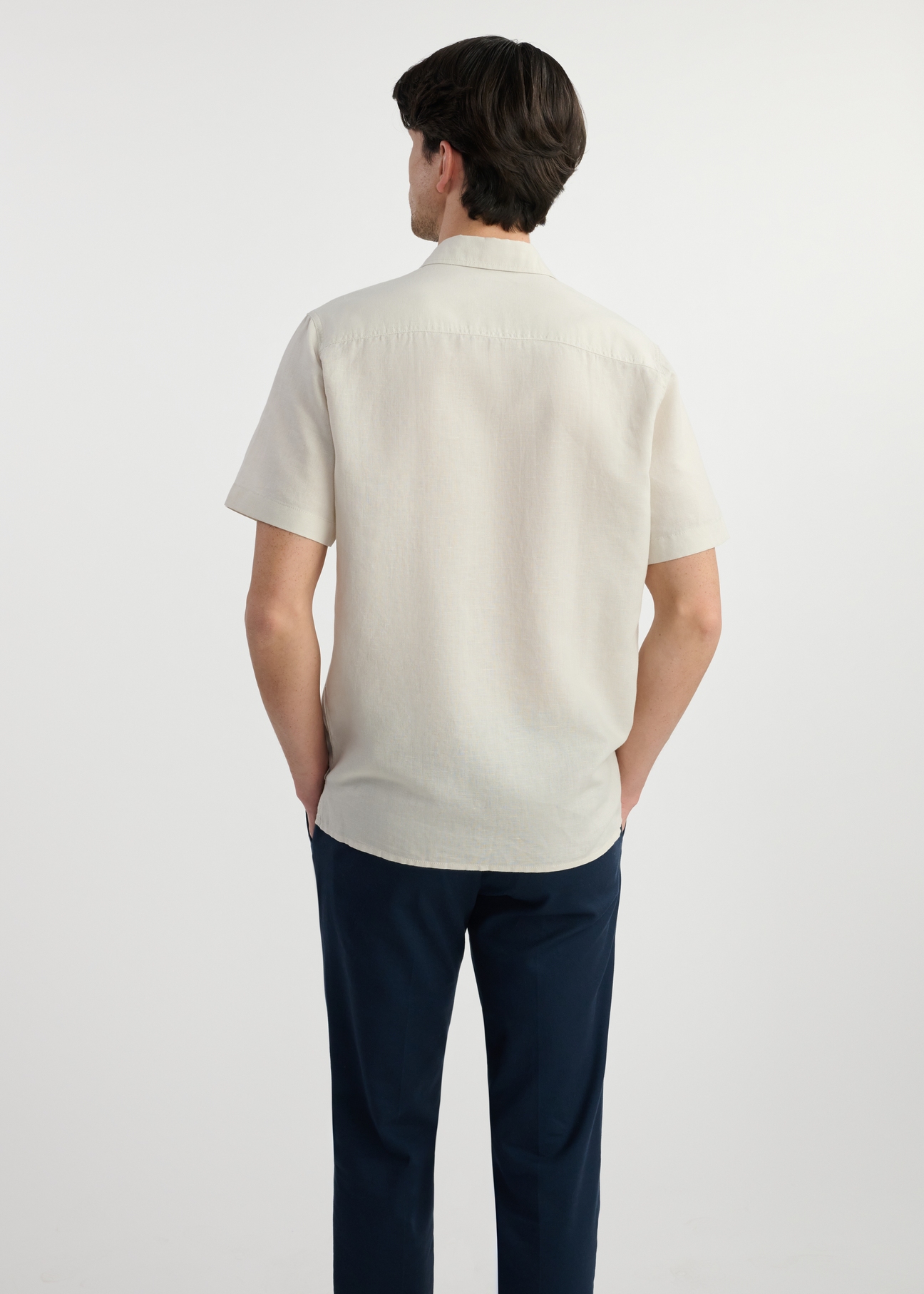 Beige men's shirt with short sleeves KOSMT-0327-81(W25) - back view on white background.