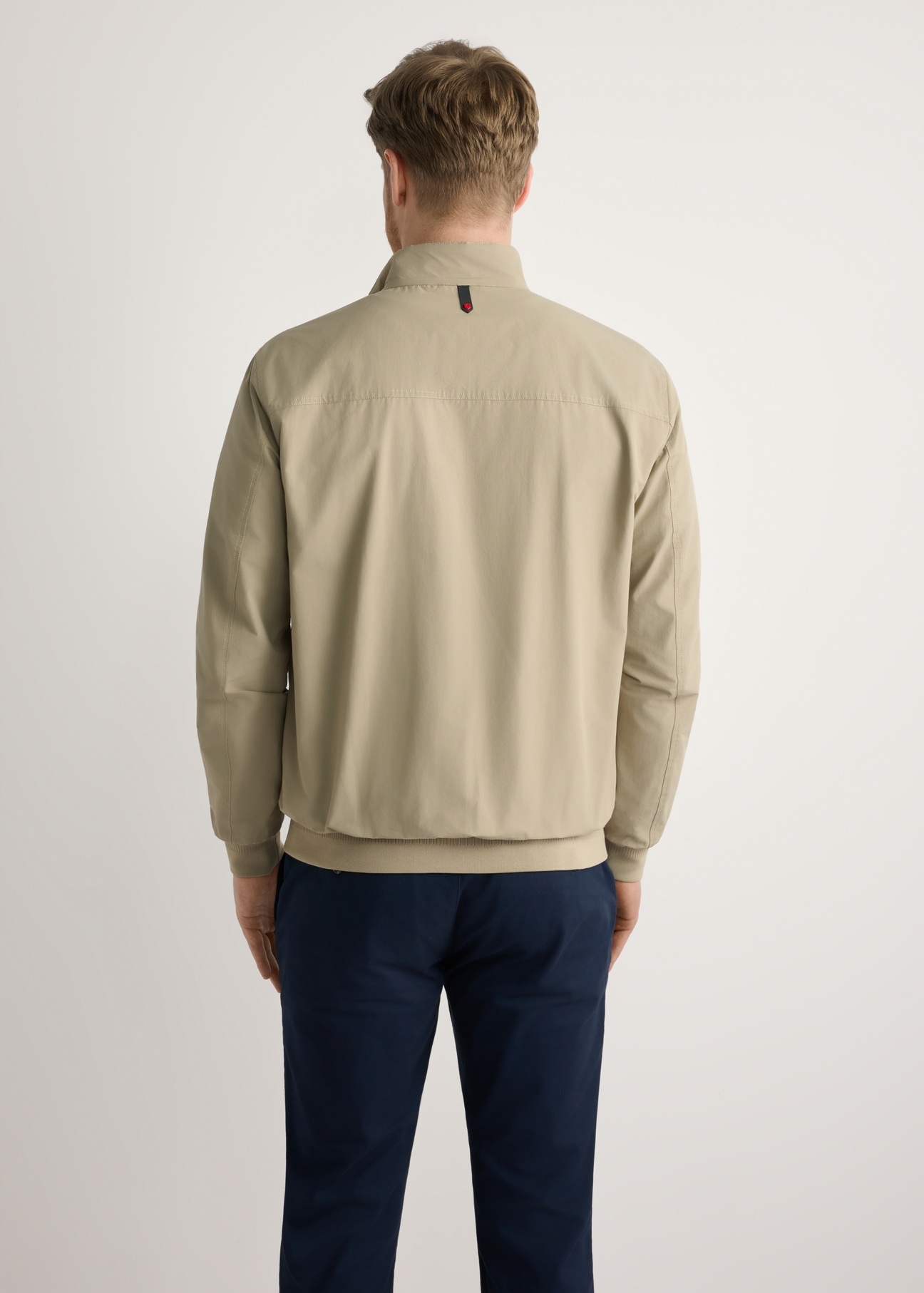 Beige men's lightweight transitional jacket KURMT-0370-1B(W26) - product view from the back, on a model, against a light background. Knee-length silhouette visible.