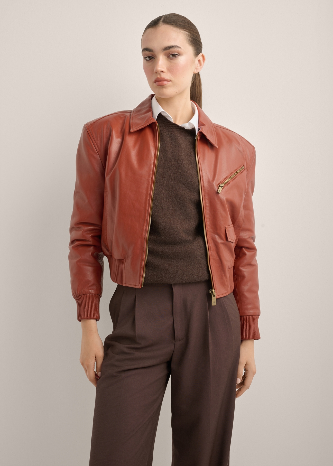 Women's red leather jacket KURDS-0624-3D(Z26), front view of the product on a model. Half of the silhouette visible.