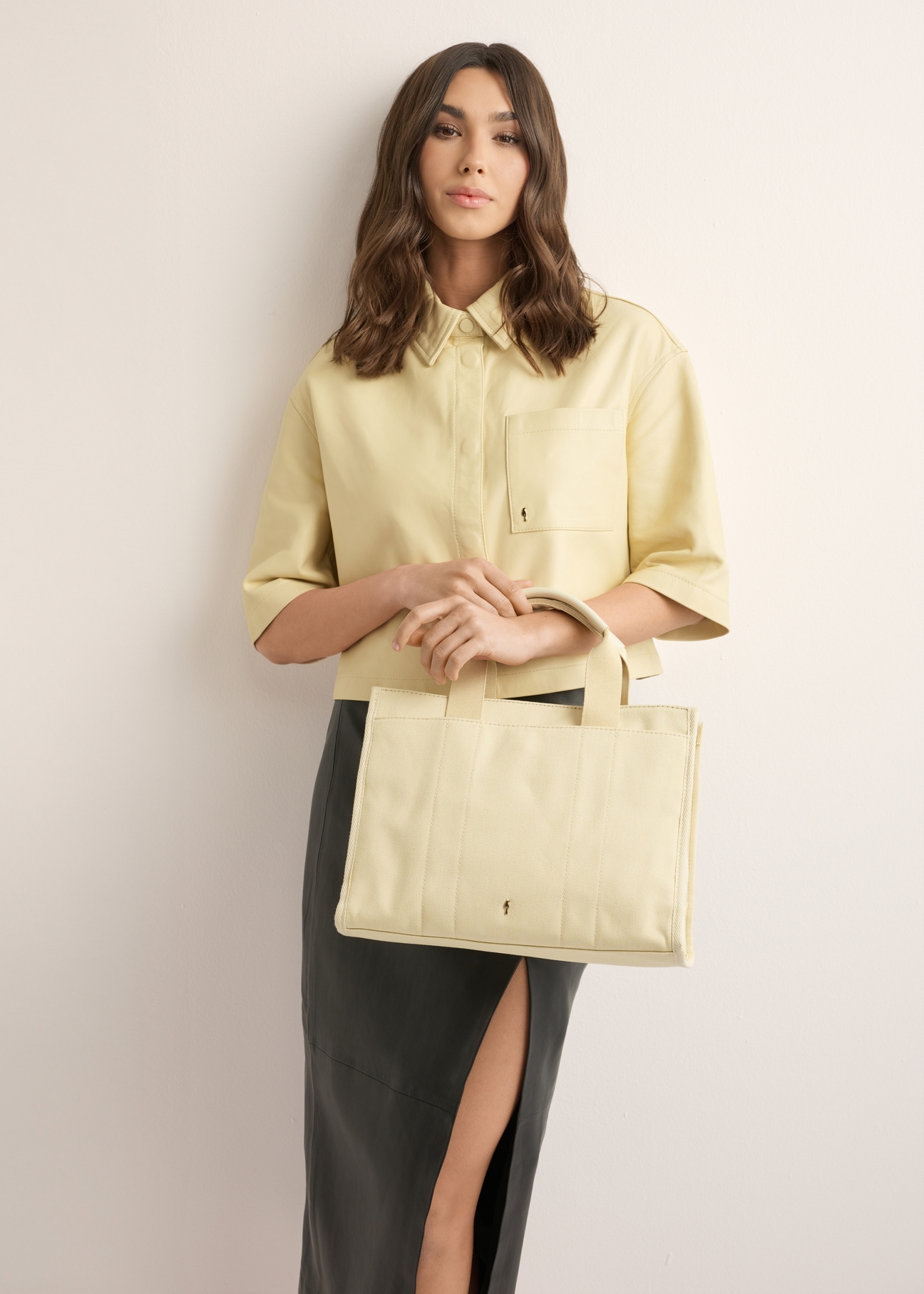 Cream cotton women's handbag TOREN-0332-0B(W26), product view on a model's silhouette, on a light background.