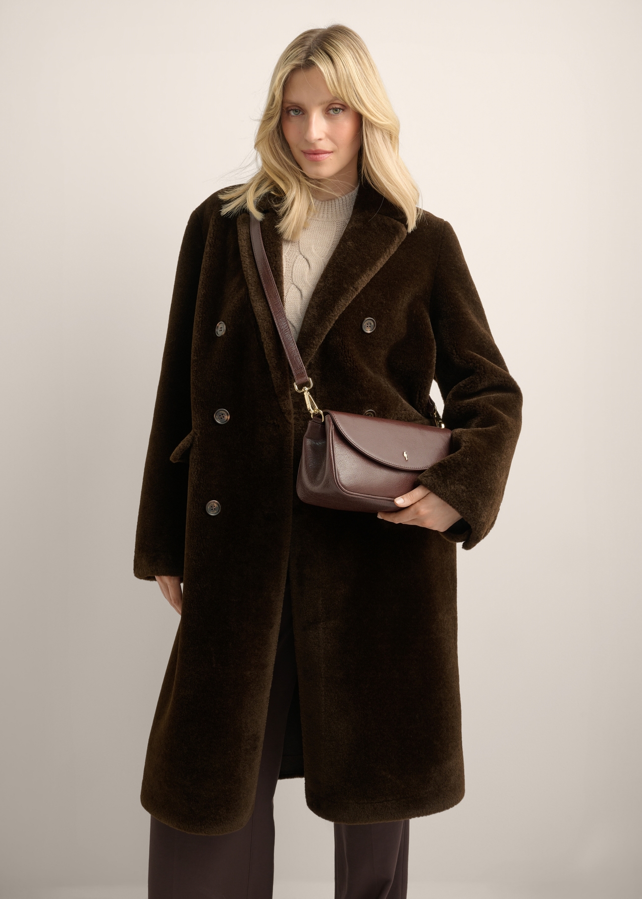 Classic brown leather women's handbag TORES-1371-1H(Z26), diagonal view of the product on the model. Half of the silhouette visible.