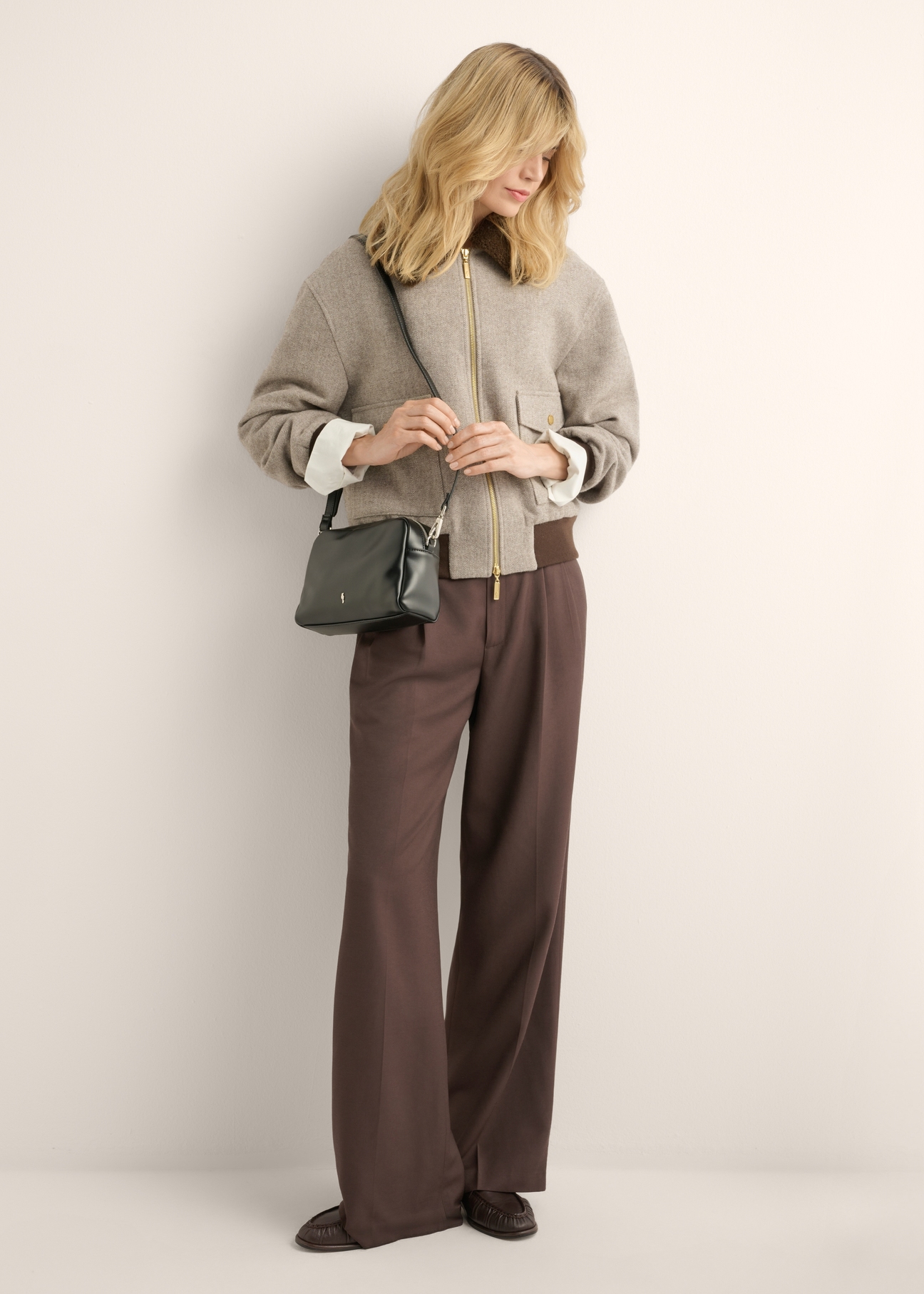 Women's black shoulder bag TOREC-1342-99(Z26), product view on model's shoulder. Full body visible.