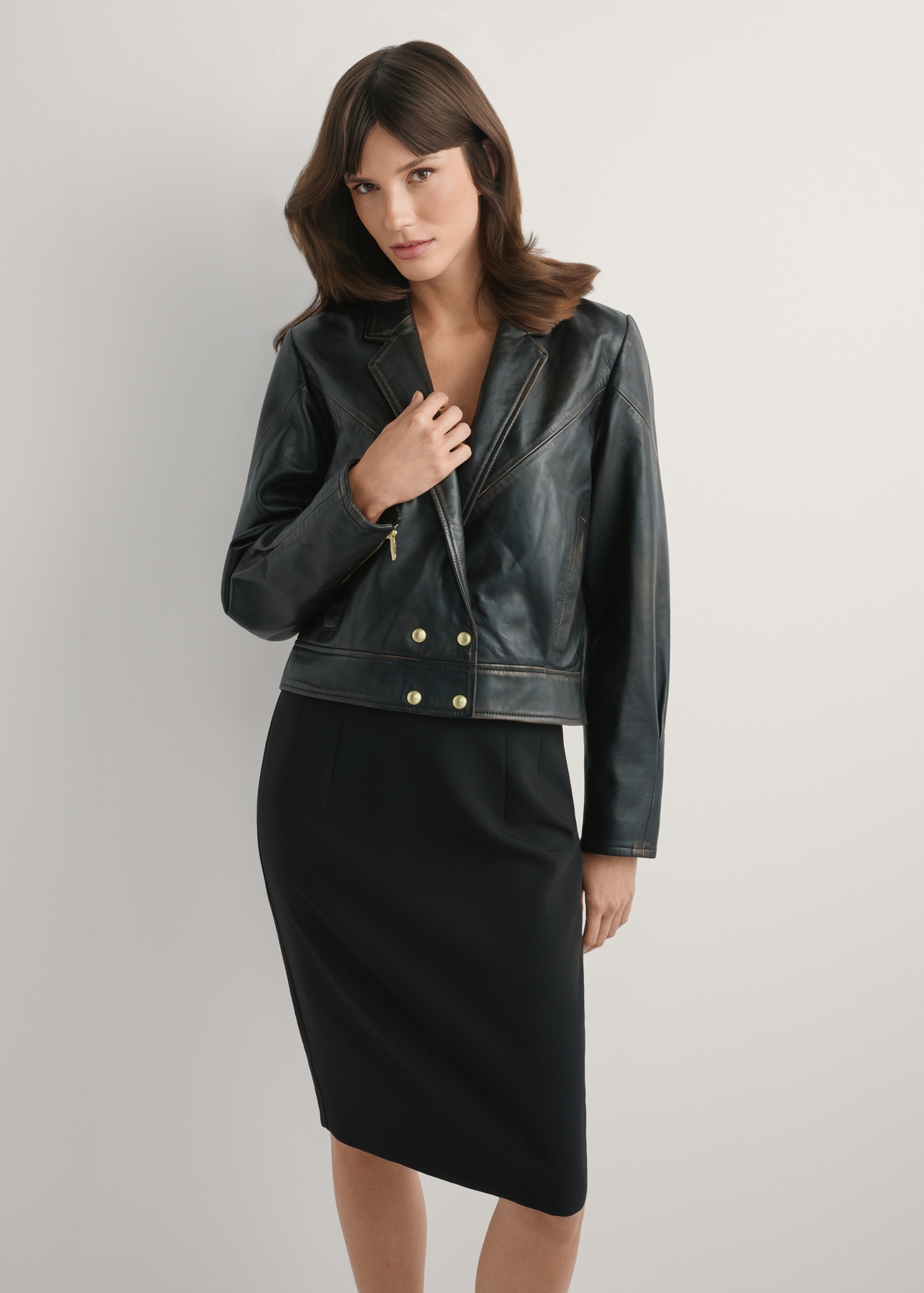 Women's vintage short leather jacket KURDS-0573-9J(W26), front view of the product on the model. Half of the silhouette visible.