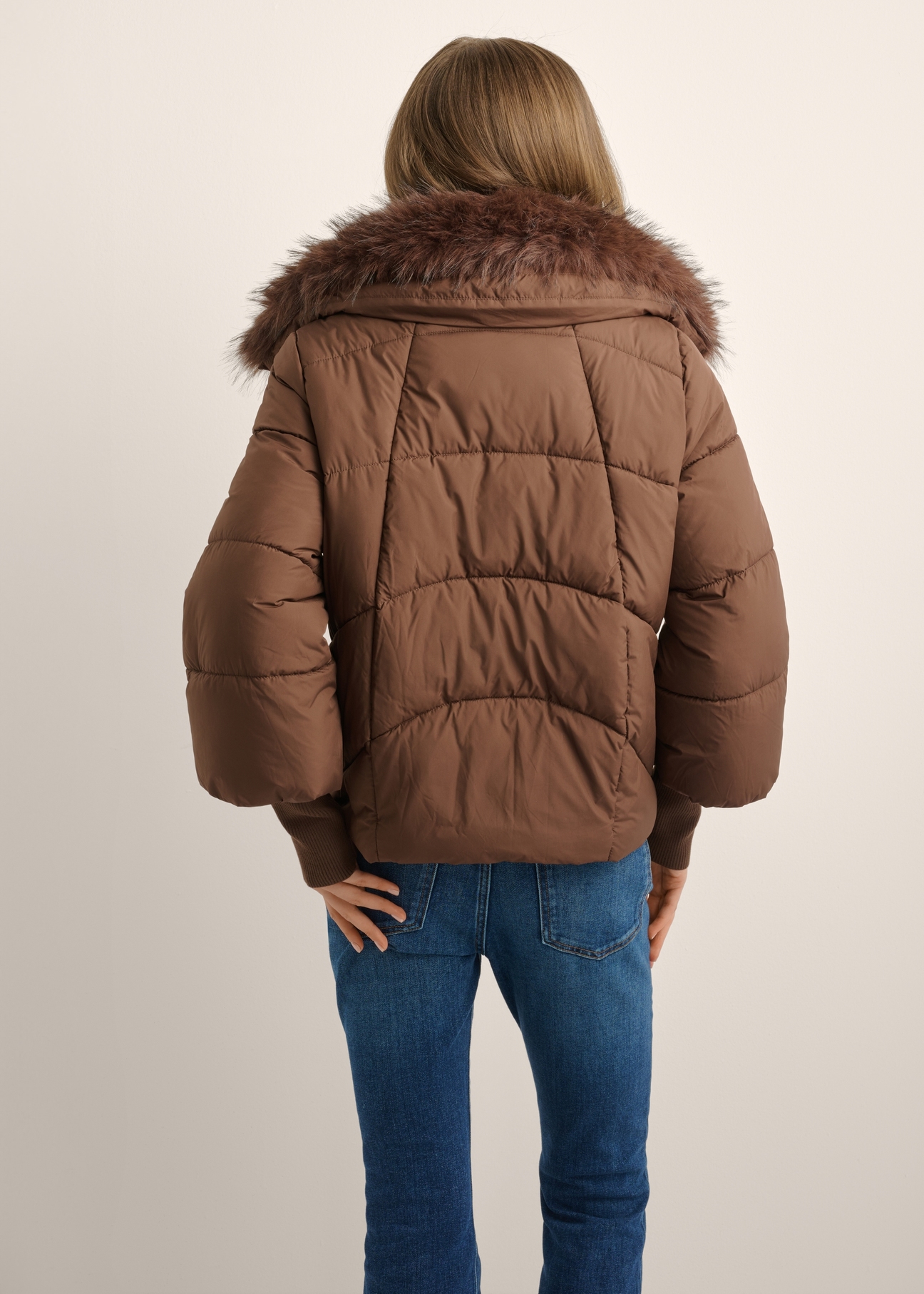 Women's brown jacket with detachable fur KURDT-0704-1H(Z26), back view of the product on the model. Half of the silhouette visible.