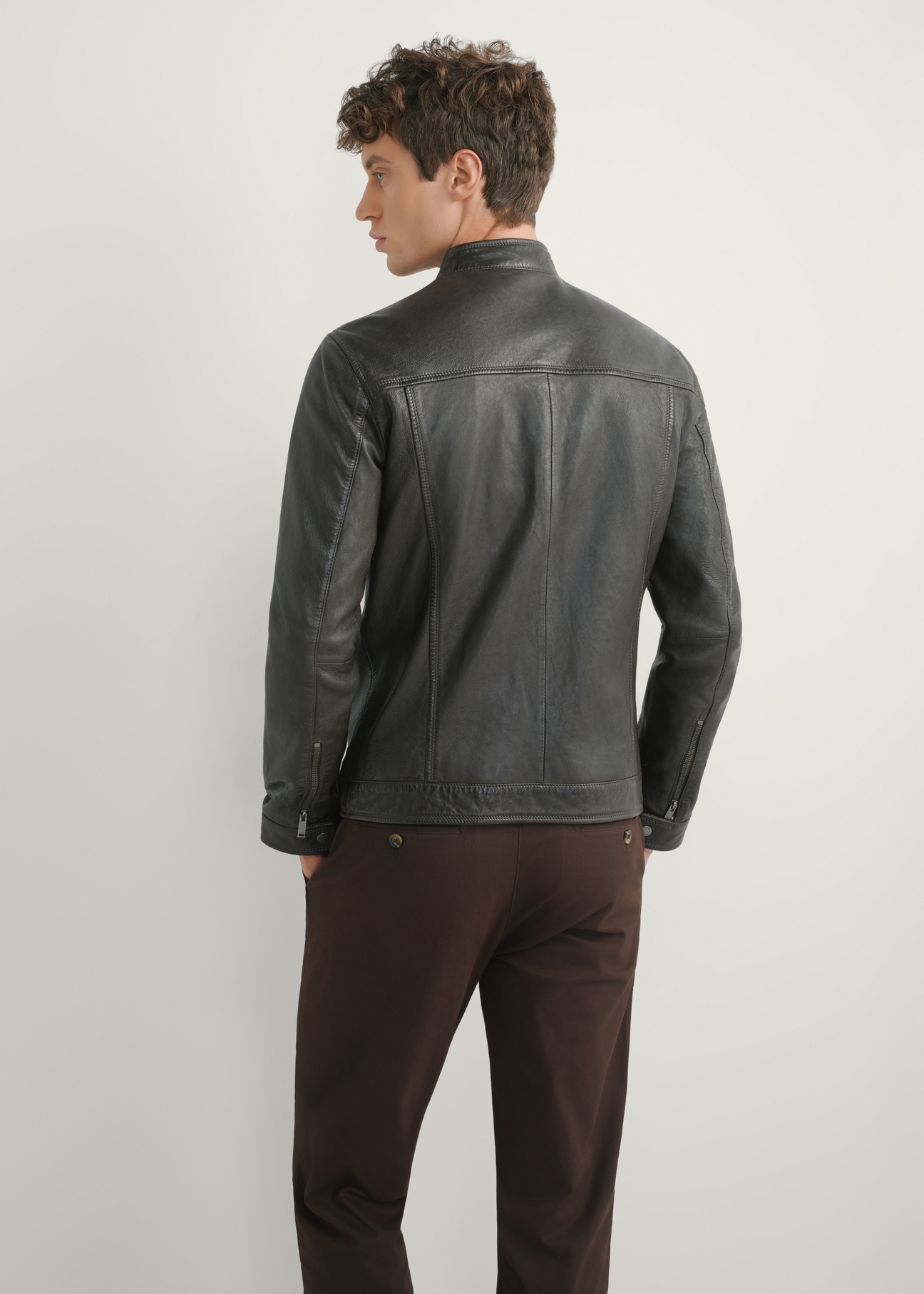 Dark brown men's leather jacket KURMS-0326-1I(W26), product view from the back on the model. Half of the silhouette visible.