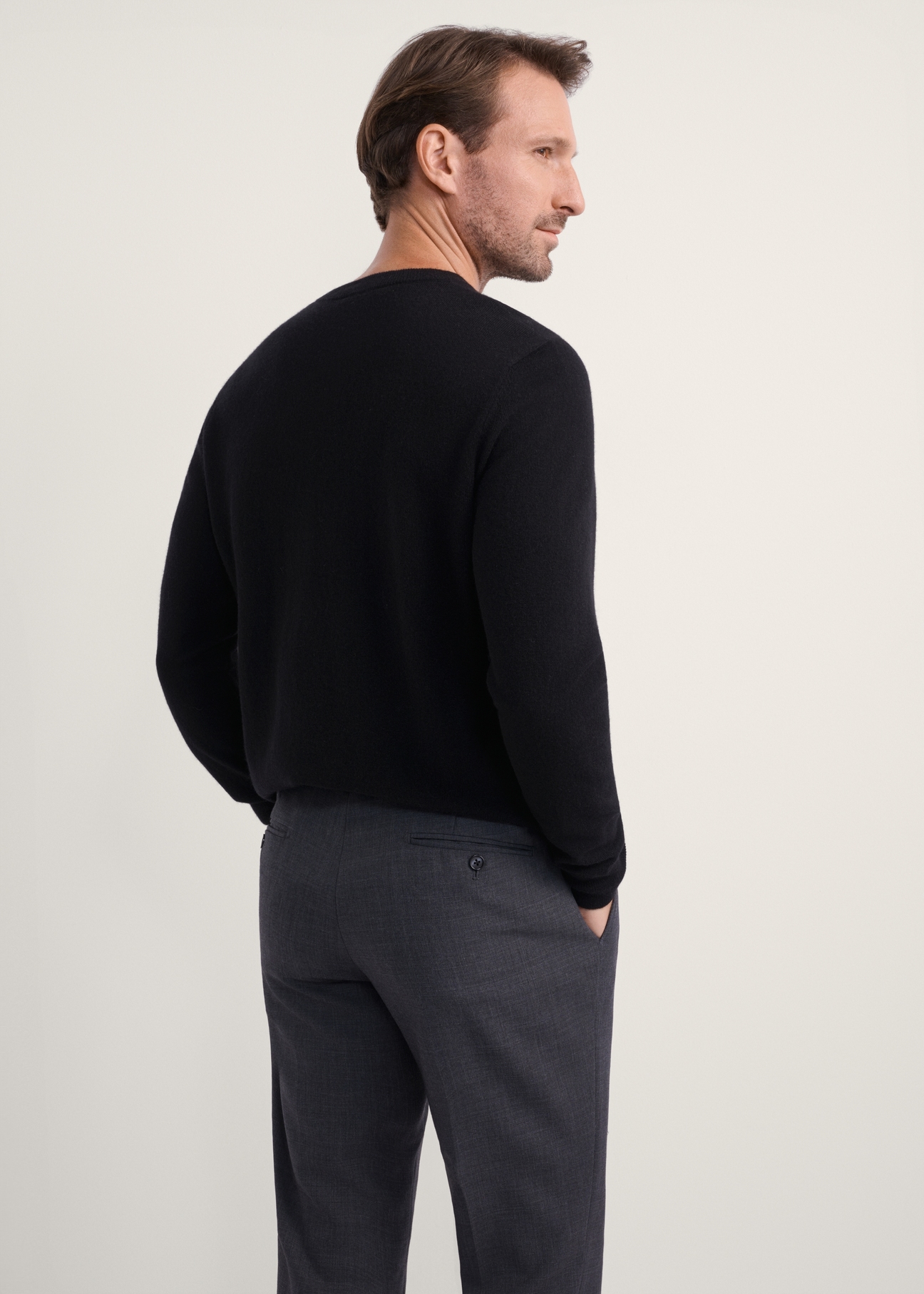 Men's black wool and cashmere sweater SWEMT-0186-99(Z25), back view of the product on the model. Half of the silhouette visible.