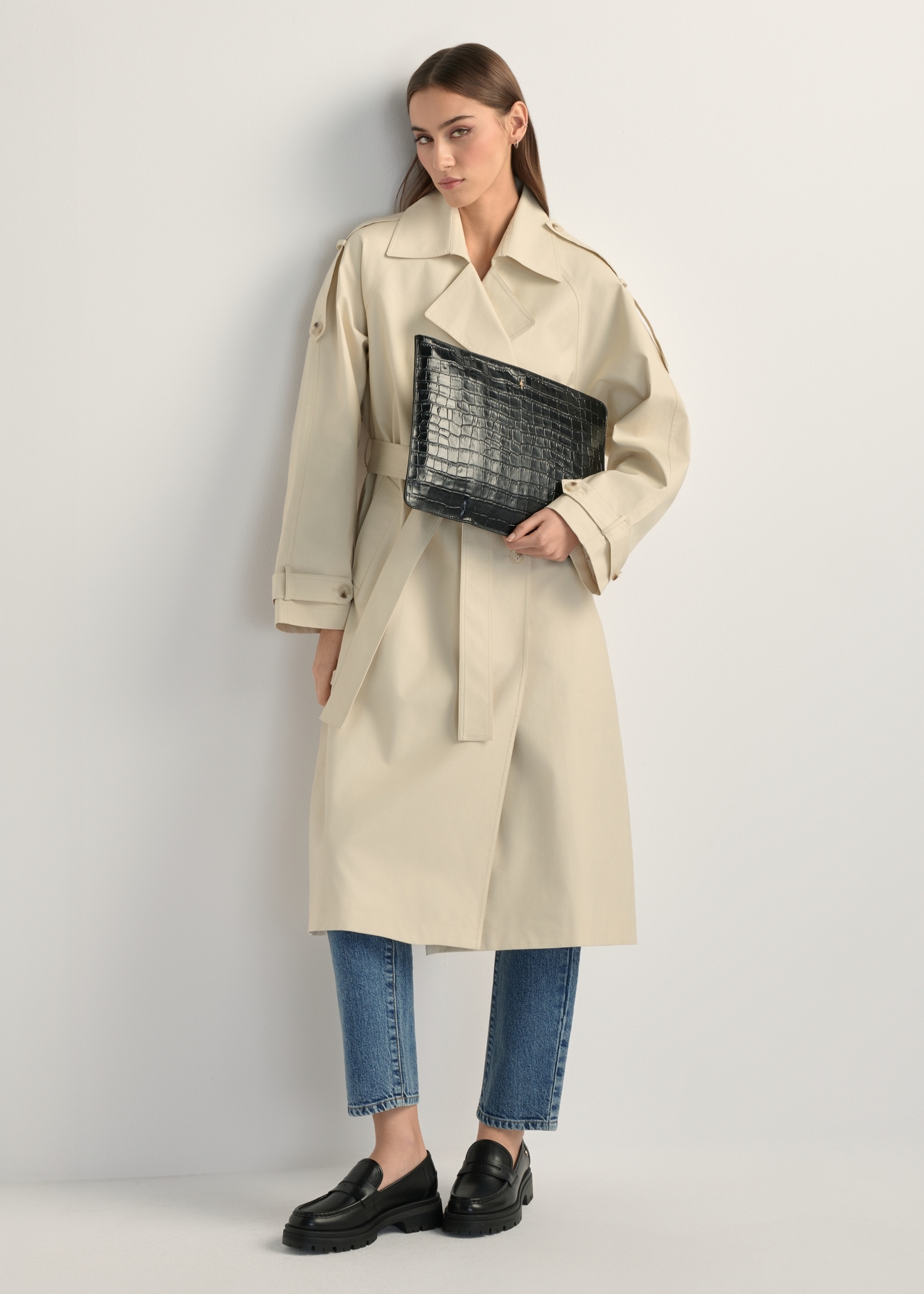 Black leather women's briefcase TORES-0853F-9G(W26) - product view slightly diagonal, on a model, against a light background. The entire silhouette is visible.