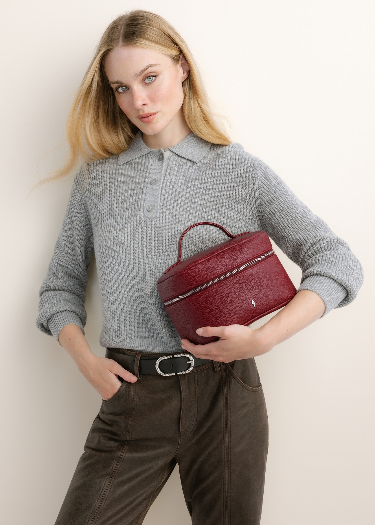Red, round women's cosmetic bag TOREC-0919-4C(Z26); front view of the product shown on a model. Half of the figure is visible.