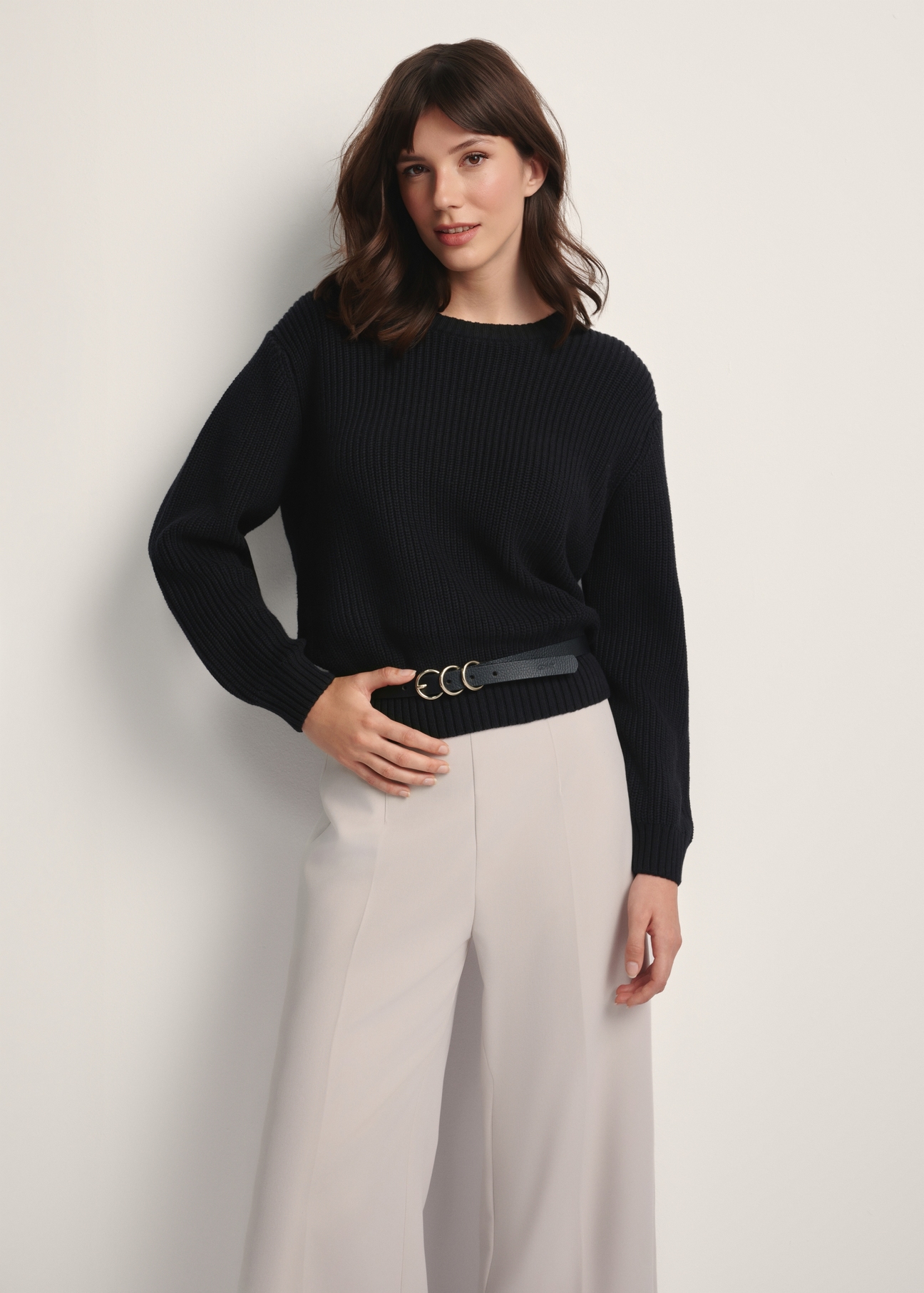 Black women's sweater SWEDT-0238-99(Z25), front view of the product on the model. Half of the silhouette visible.