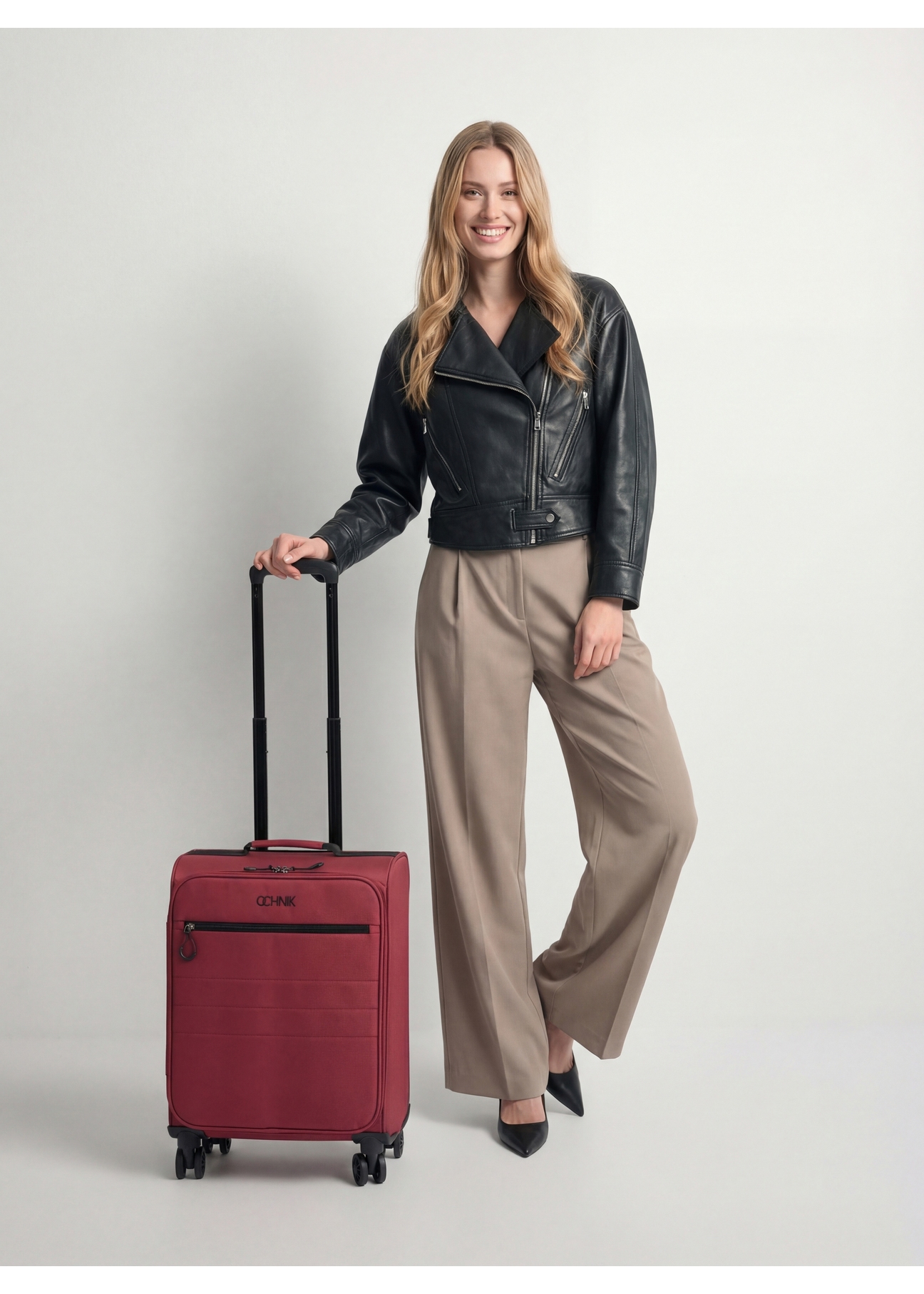 Medium suitcase on wheels WALNY-0045-4B-24(W26), front view of the product next to the model's silhouette.