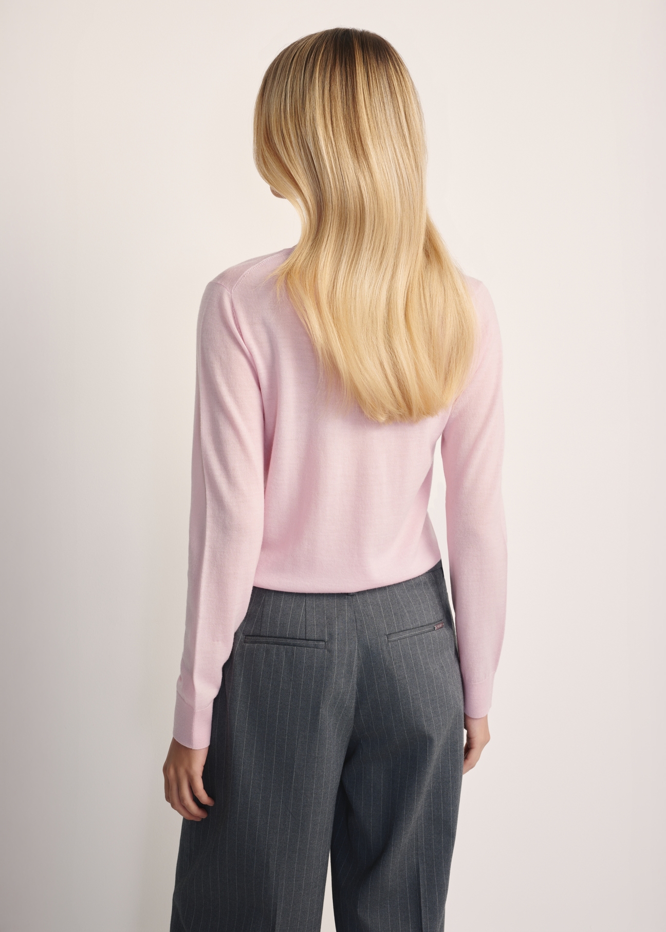 Light pink women's sweater SWEDT-0250-34(Z25), product view from the back on the model. Half of the silhouette visible.