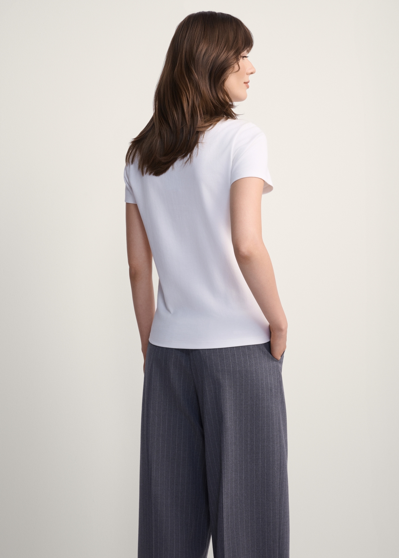 White cotton women's t-shirt TSHDT-0144-11(Z25), product view from the back on the model, half of the silhouette visible.