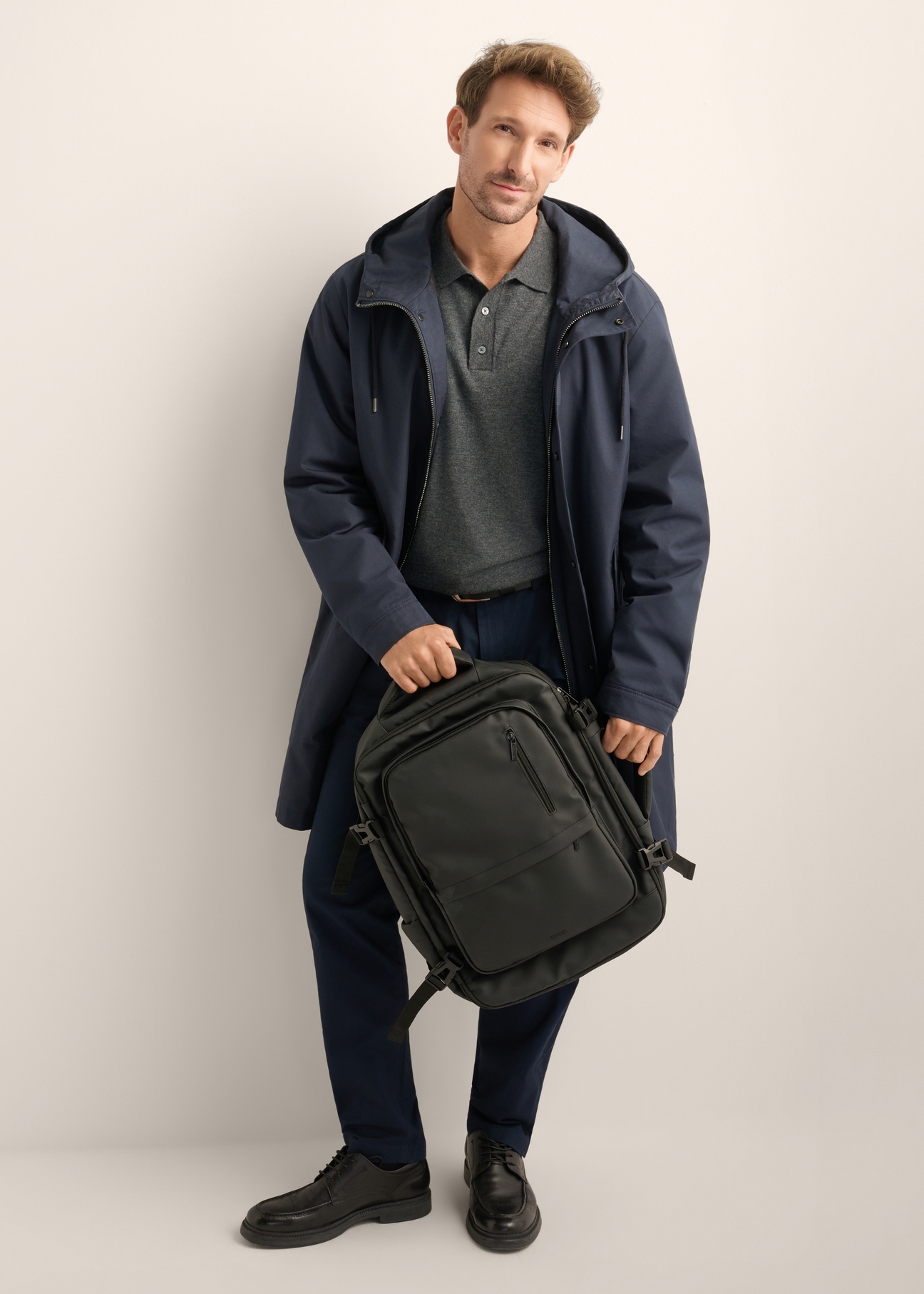 Black large travel backpack PLCMN-0018-99(Z26), product view from the front on the model, the entire silhouette is visible.