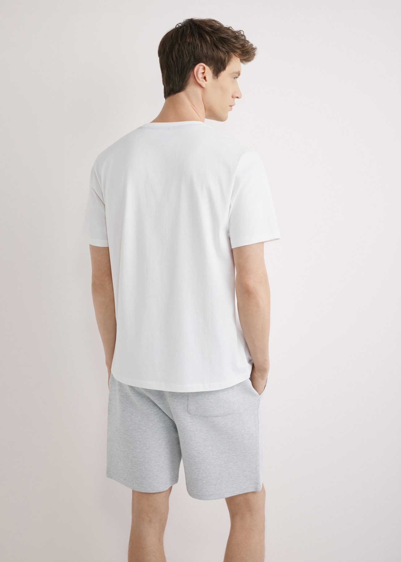 Men's white T-shirt with print TSHMT-0145-0A(W26), back view of the product on the model. Half of the silhouette visible.