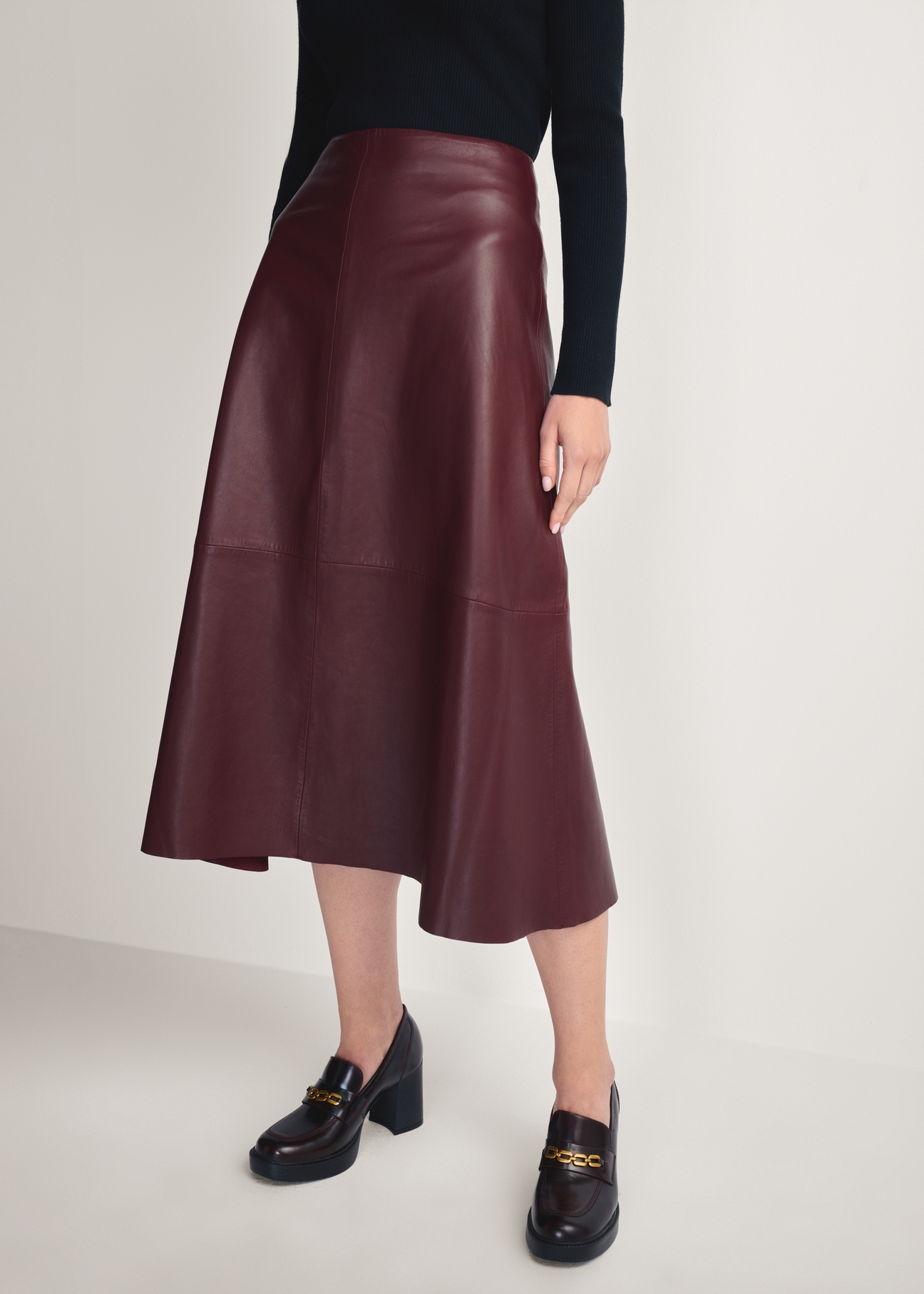 Burgundy leather midi skirt SPCDS-0077-2869(Z25), front product view on model. Half of the silhouette visible.