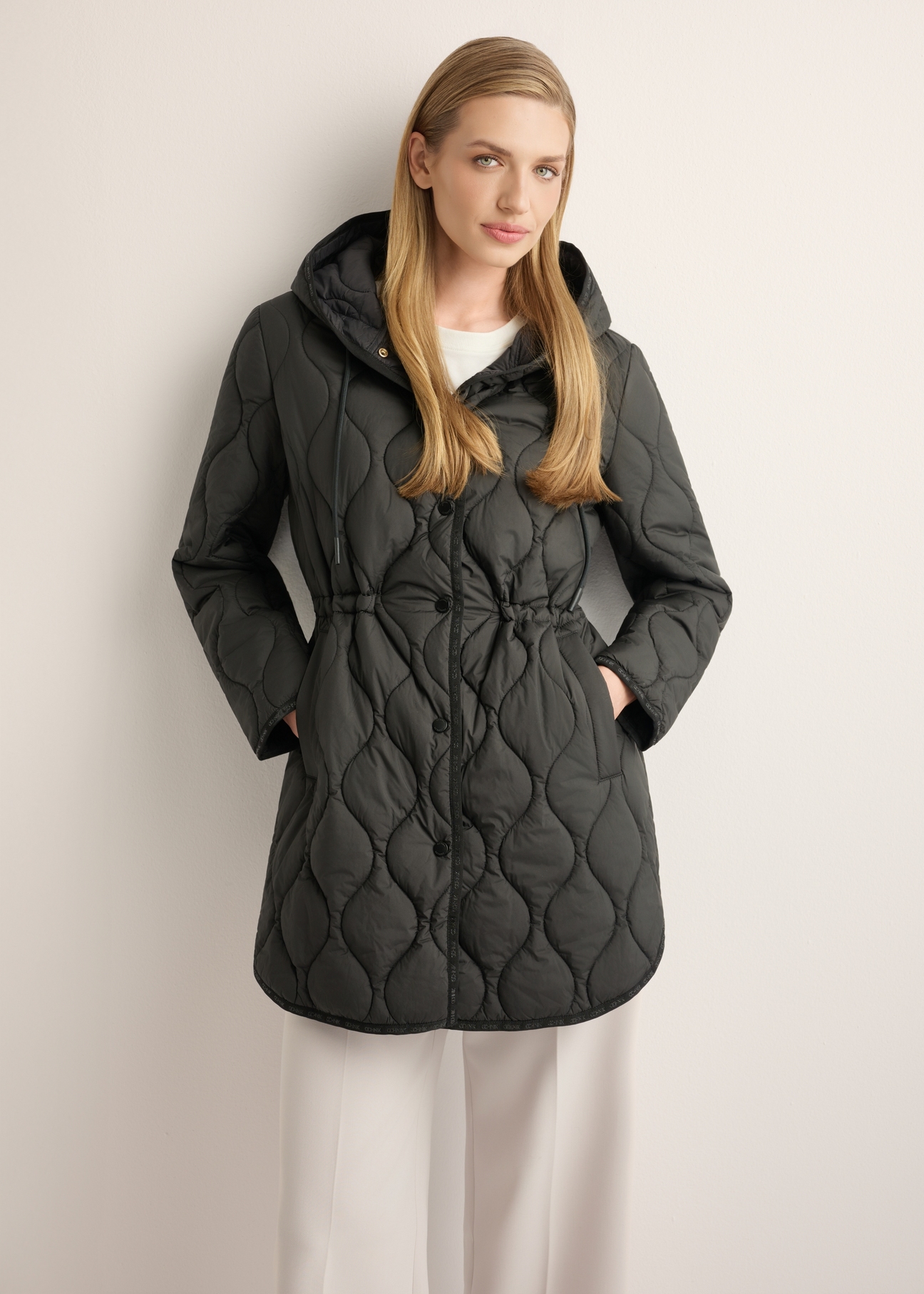 Women's black quilted jacket KURDT-0654-99(W26), front view of the product on the model. Half of the silhouette visible.