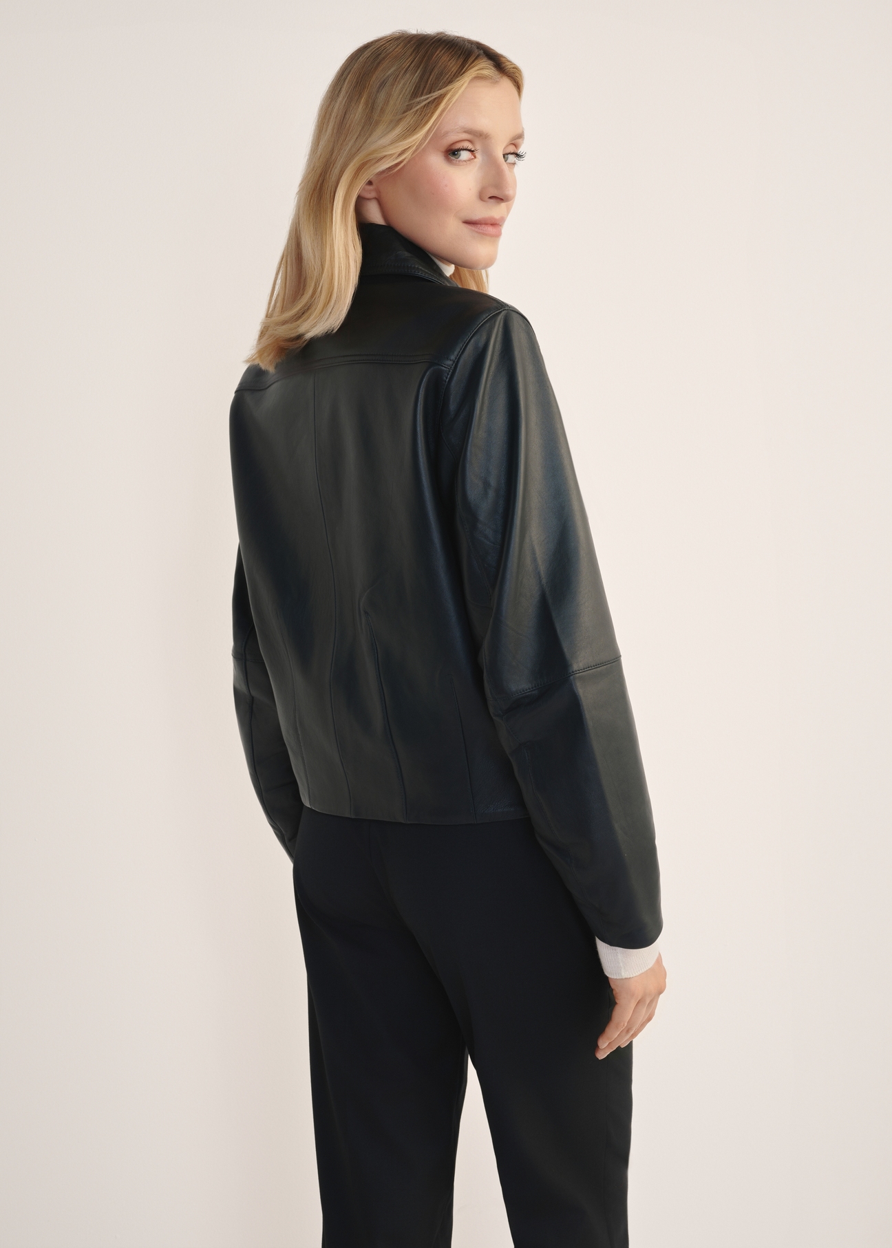 Women's leather button jacket KURDS-0578-3184(W25), product view from the back on the model, half of the silhouette visible.