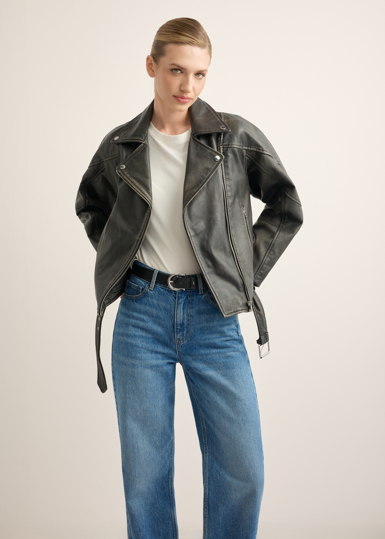 Women's leather biker jacket KURDS-0605-99(W26), front view of the product on the model. Half of the silhouette visible.