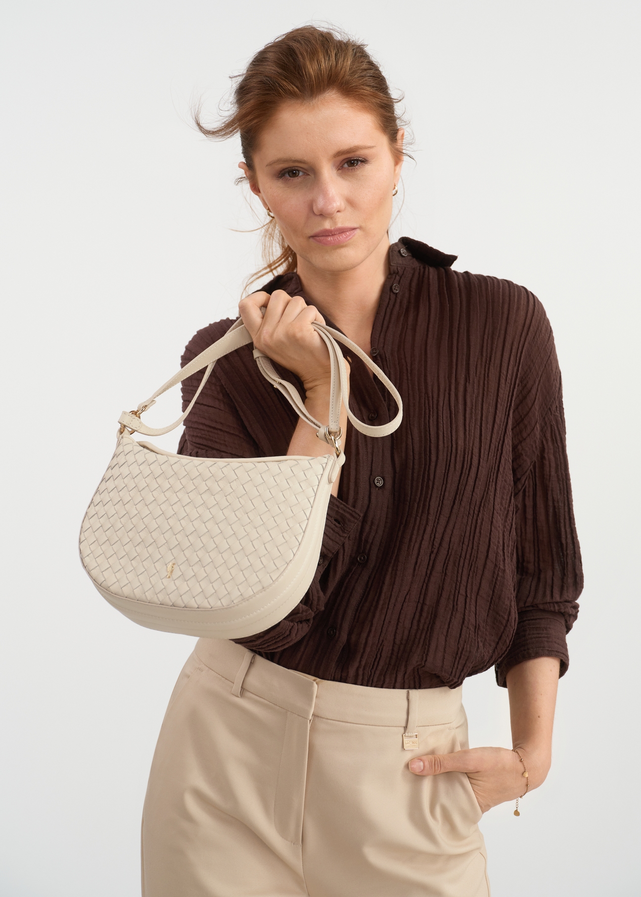 Cream braided leather messenger bag TORES-1109-12(W25) - view on a model on a white background.