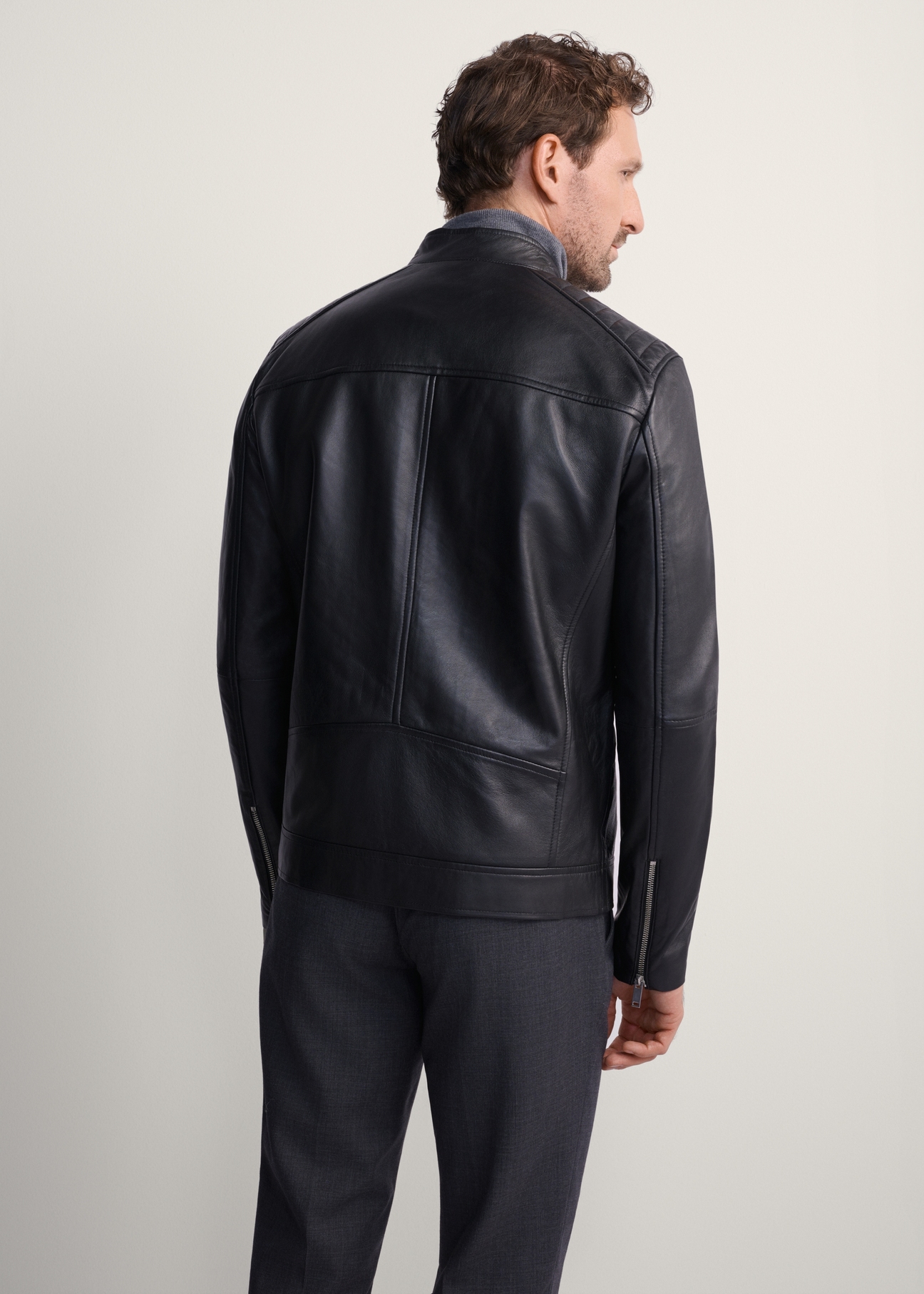 Men's leather jacket with stand-up collar KURMS-0191-5491(KS), product view from the back on the model. Half of the silhouette visible.