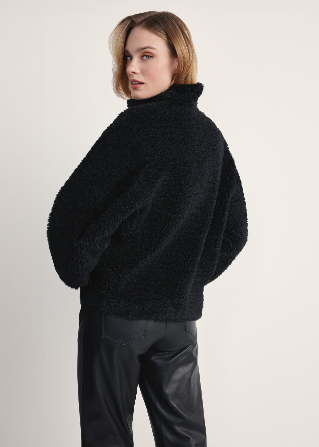 Women's black fur coat FUTDP-0021B-99(Z25), back view of the product on the model. Half of the silhouette visible.