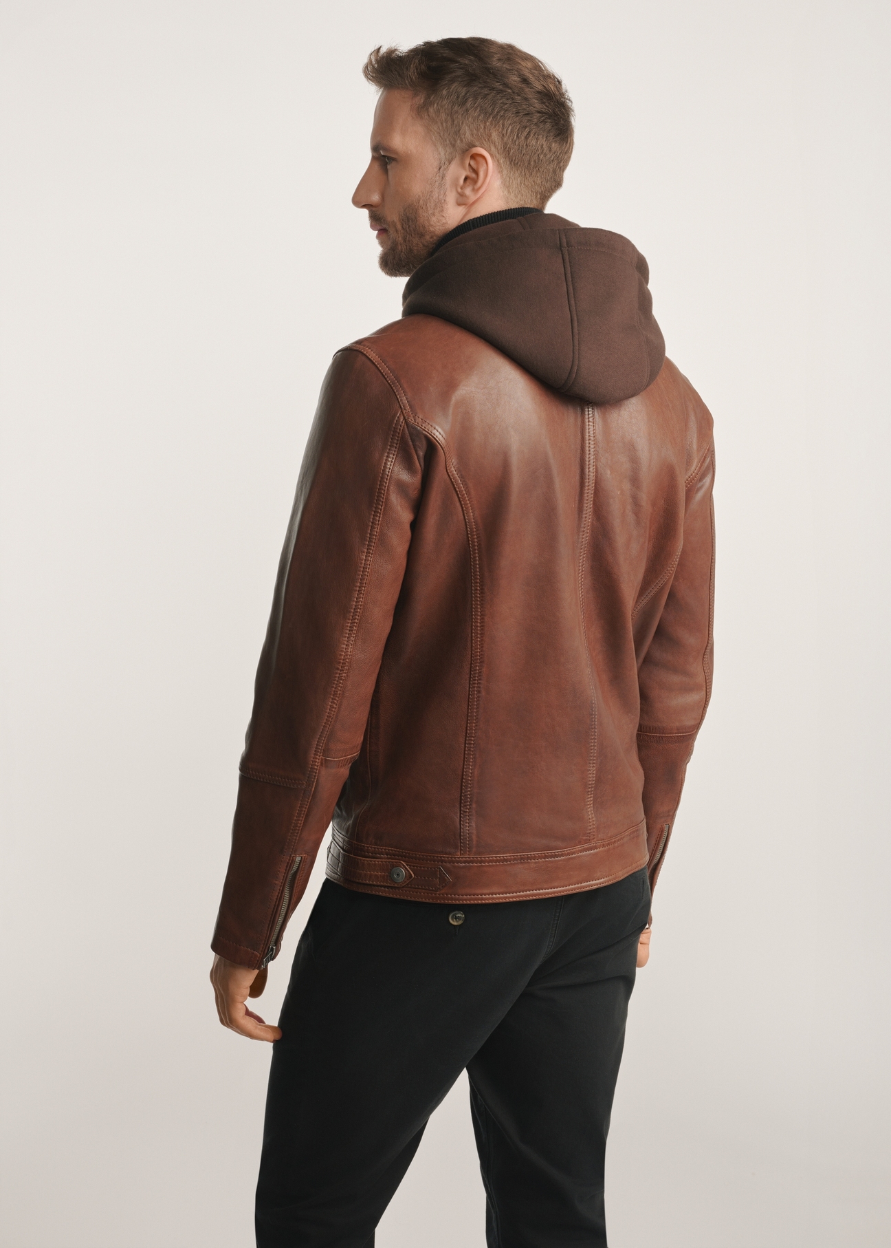 Brown men's leather jacket with hood KURMS-0385-2875(Z25), product view from the back on the model, half of the silhouette visible.