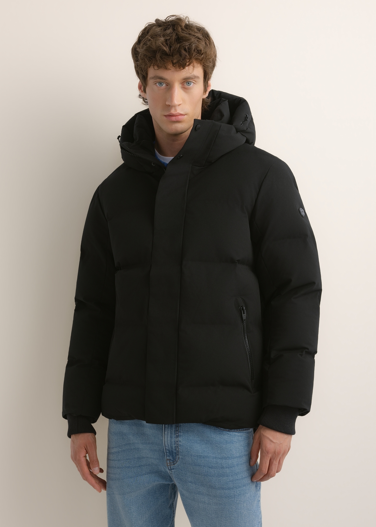 Men's black winter jacket KURMT-0447-99(Z26), front view on a model. Half-body shot.