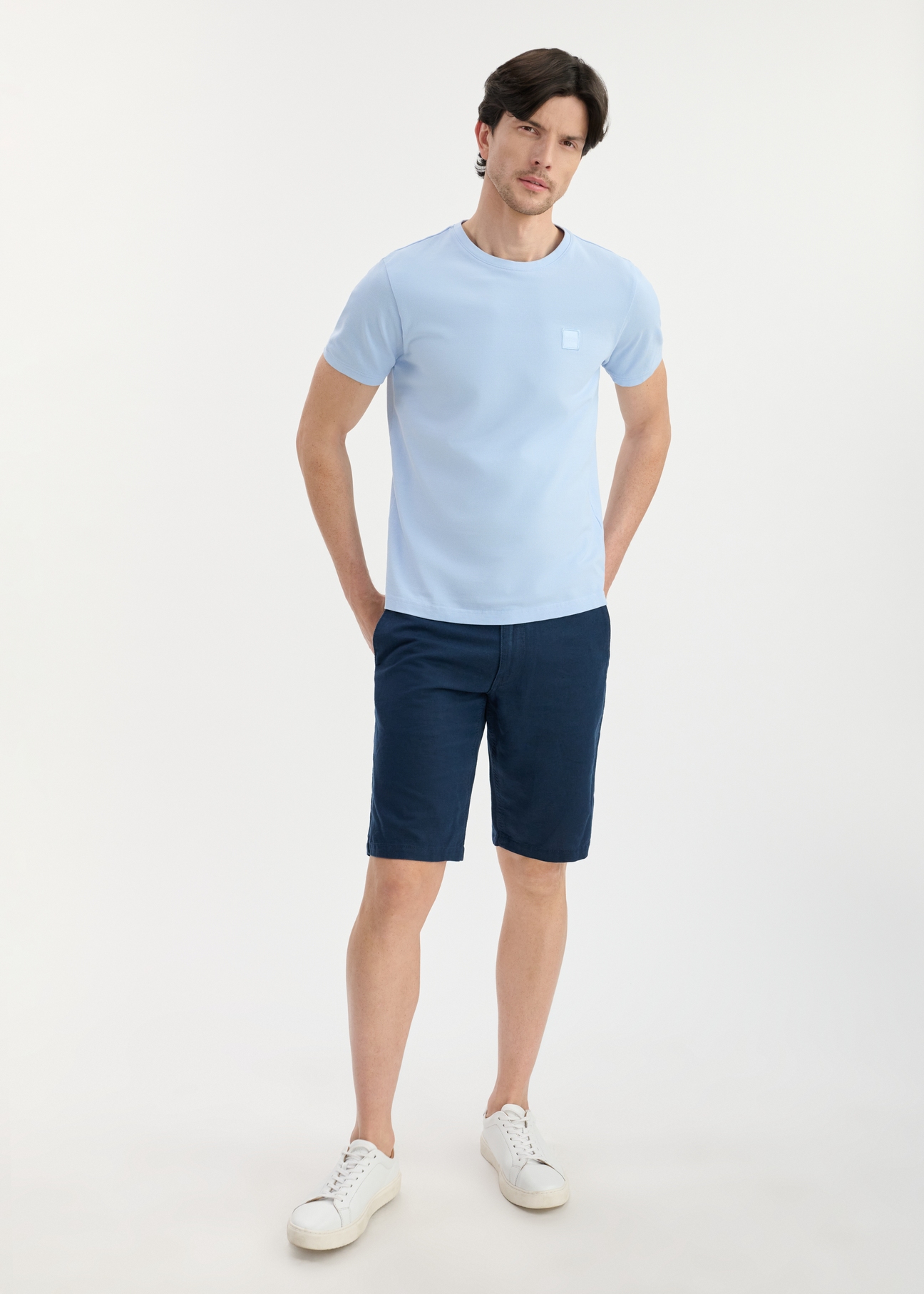 Light blue men's cotton T-shirt TSHMT-0100-60(W25), front view of the product on the model. The entire silhouette is visible.