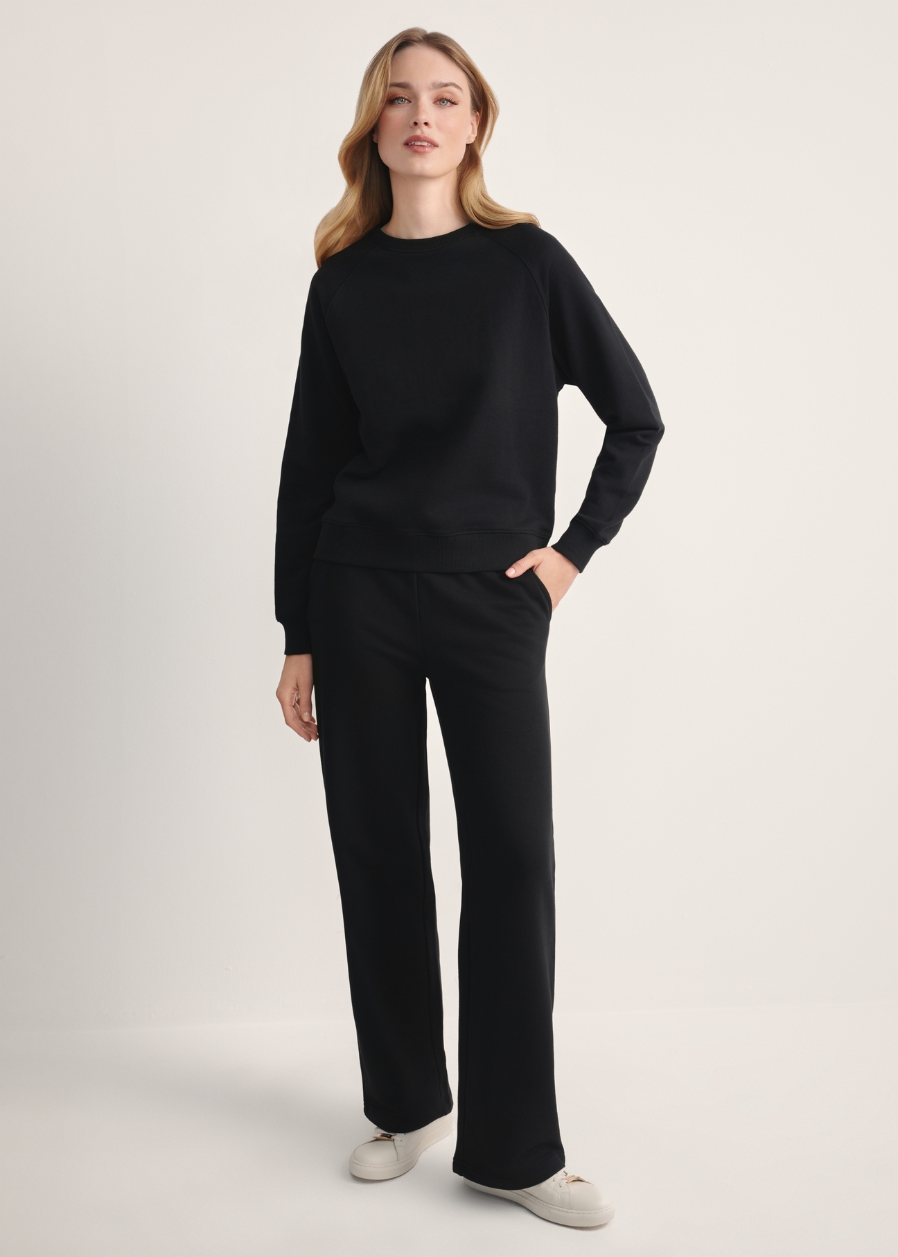 Black women's trousers SPODT-0111-99(Z25), front view of the product on the model. Full body visible.