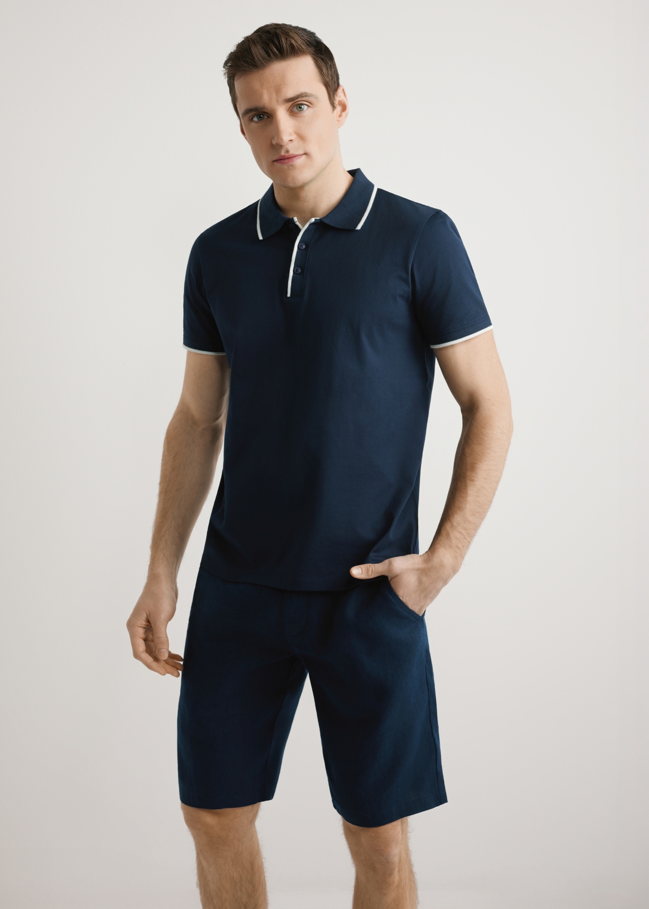 Men's dark navy polo shirt POLMT-0092-7E(W26), front view of the product on the model. Half of the silhouette visible.