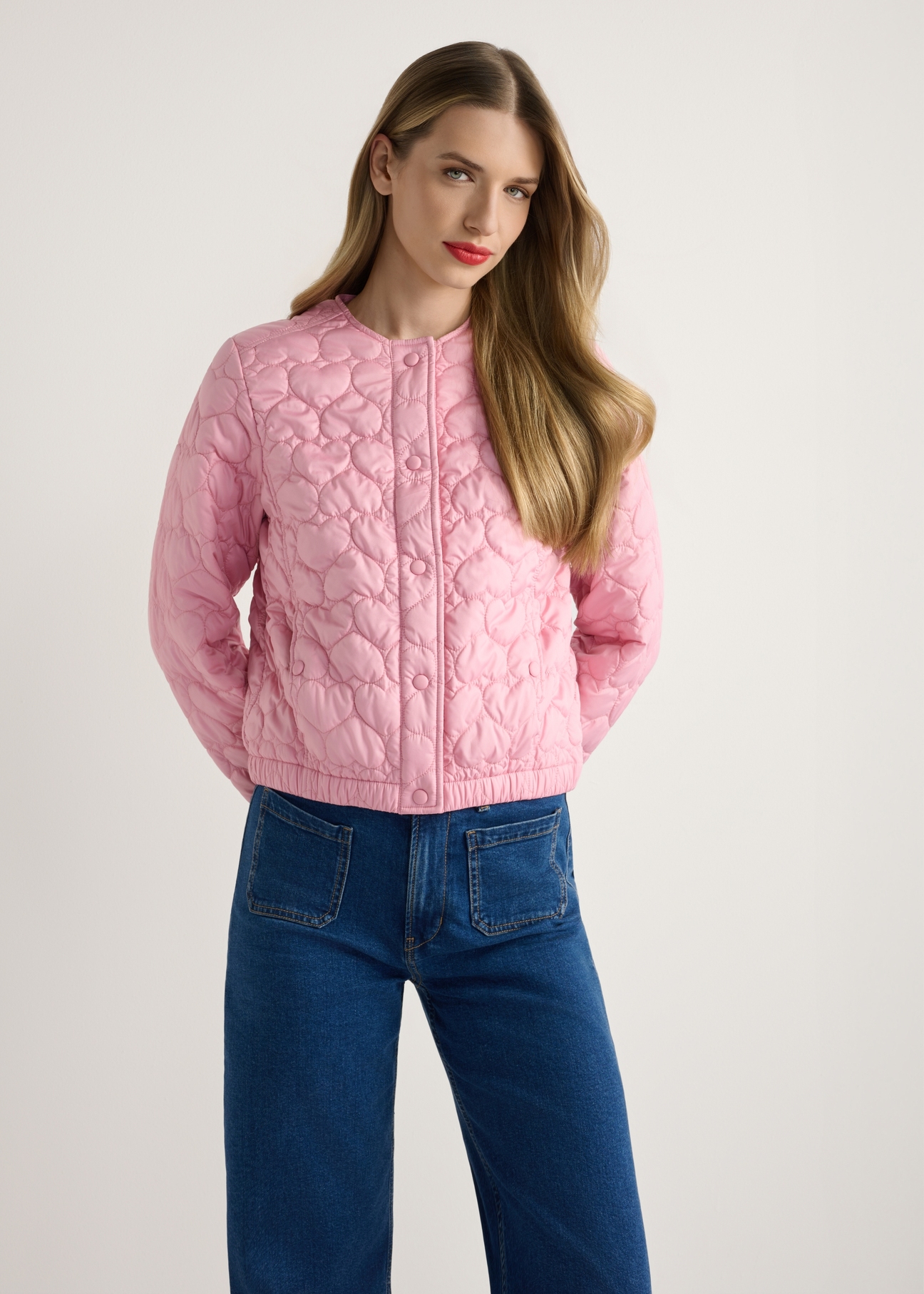Pink women's quilted jacket KURDT-0630-5B(W26), product view from the front on the model, half of the silhouette visible.