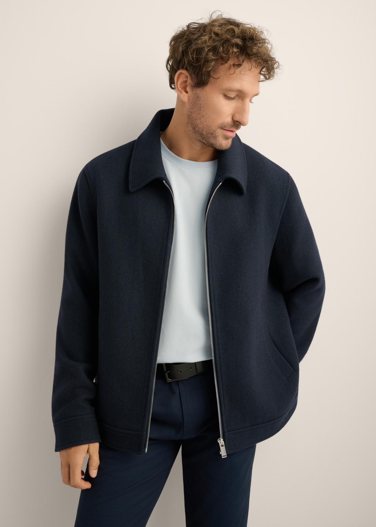 Navy blue men's wool coat PLAMT-0010-7D(Z26). Front view of the product on a model. Half of the silhouette is visible. 