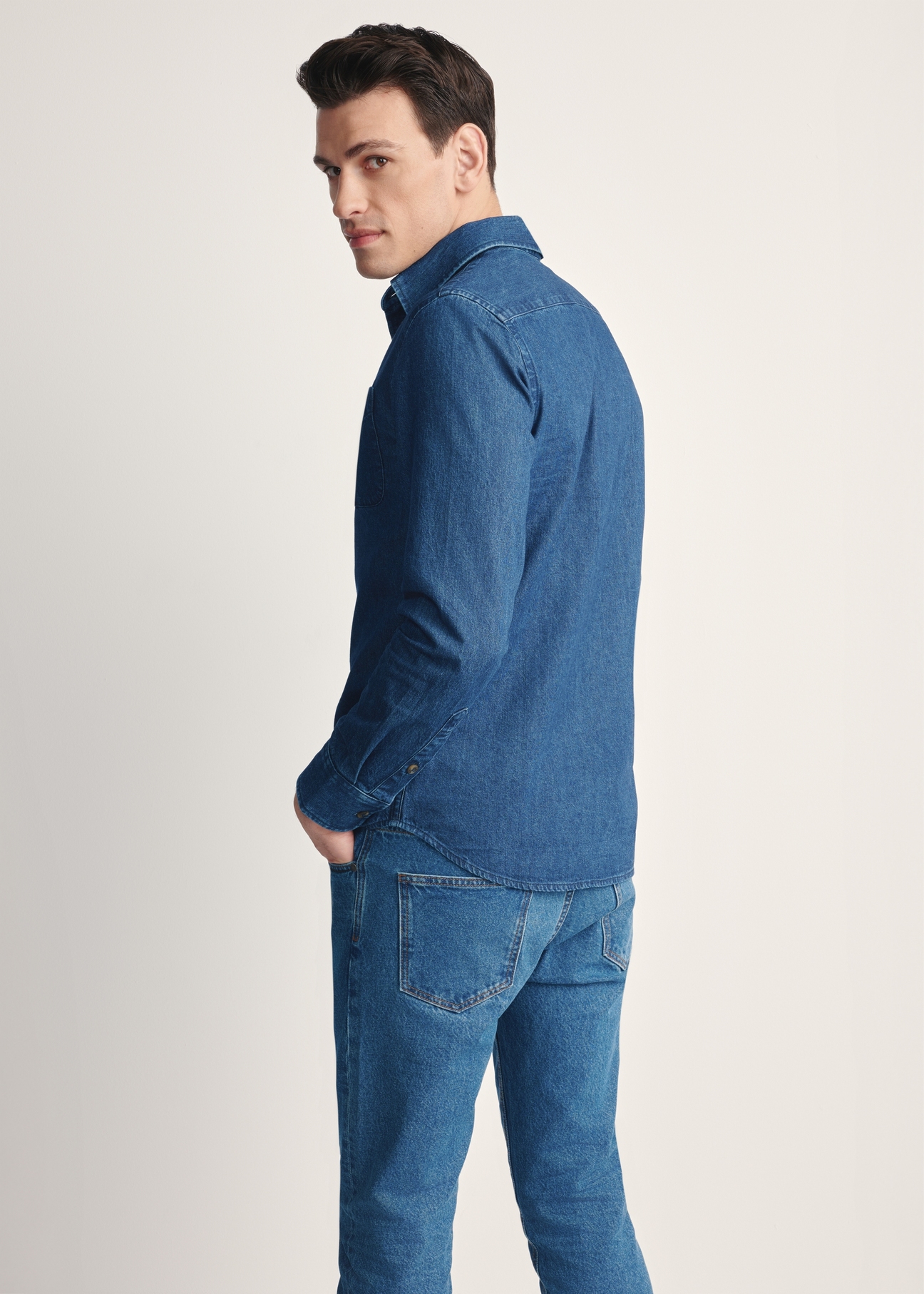 Blue men's denim shirt KOSMT-0348-61(Z25), product visible from the back on the model, half of the silhouette visible.