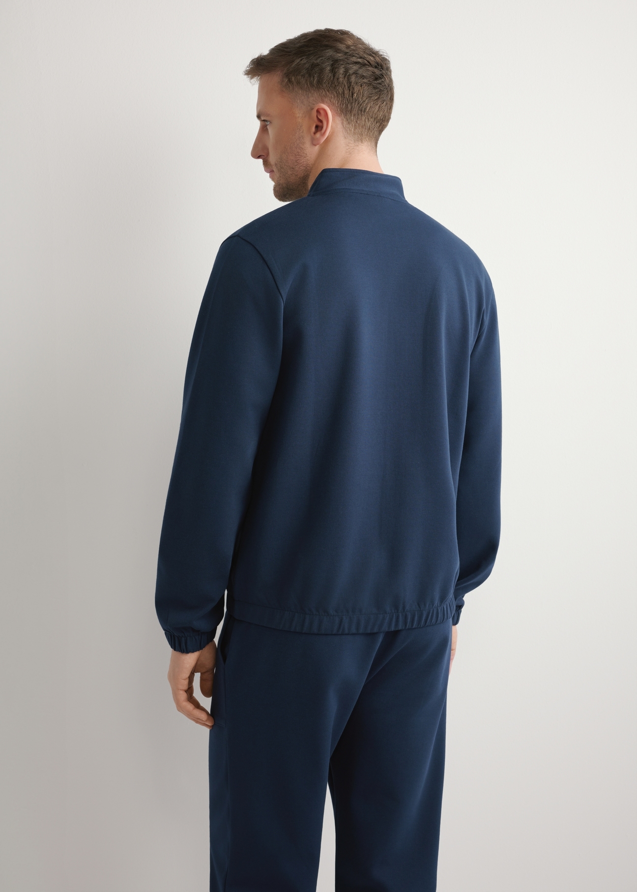 Navy blue men's zip-up sweatshirt BLZMT-0072-7E(W26), back view of the product on the model. Half of the silhouette visible.