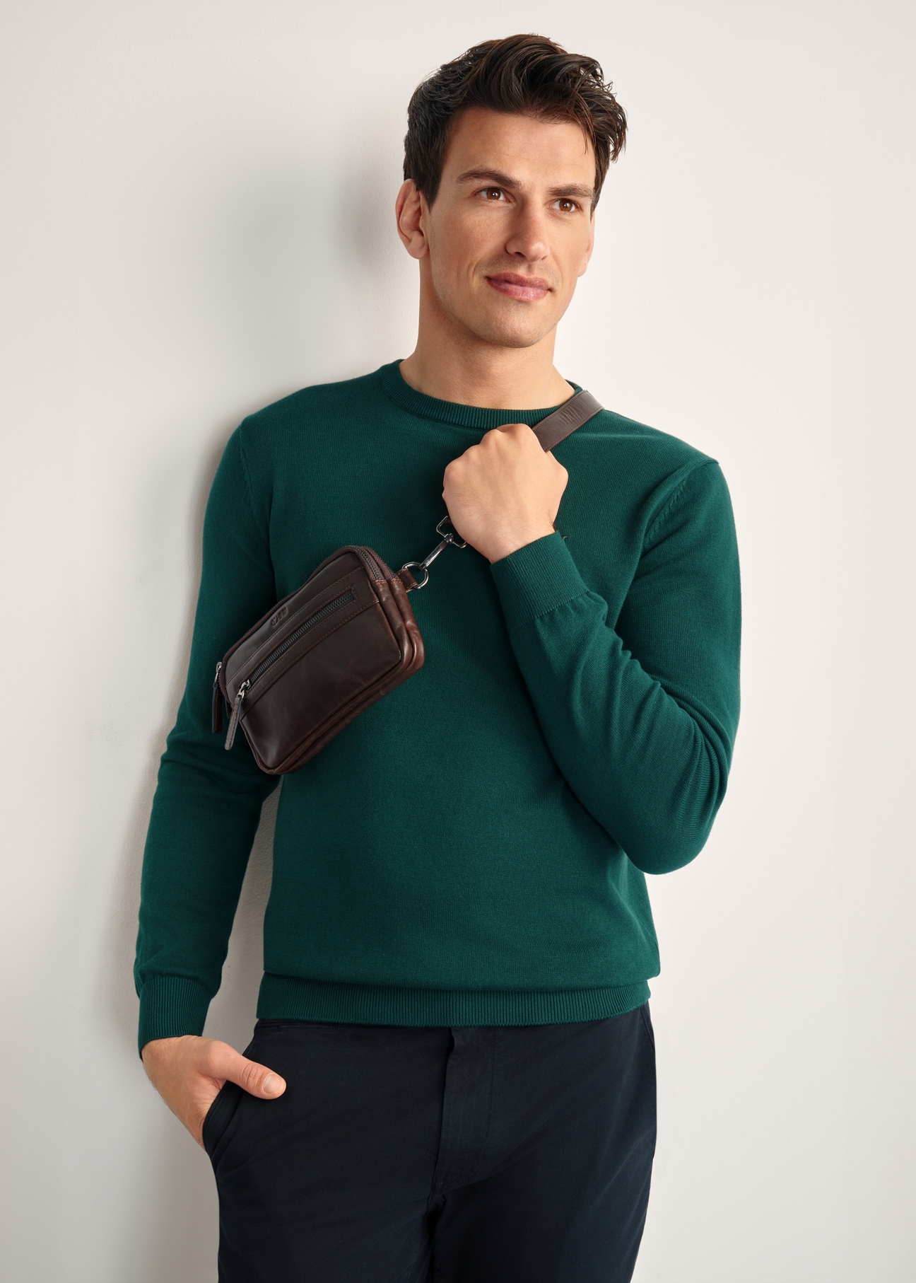 Men's brown leather waist bag TORMS-0462-89(Z25), diagonal view of the product on the model, half of the silhouette visible.