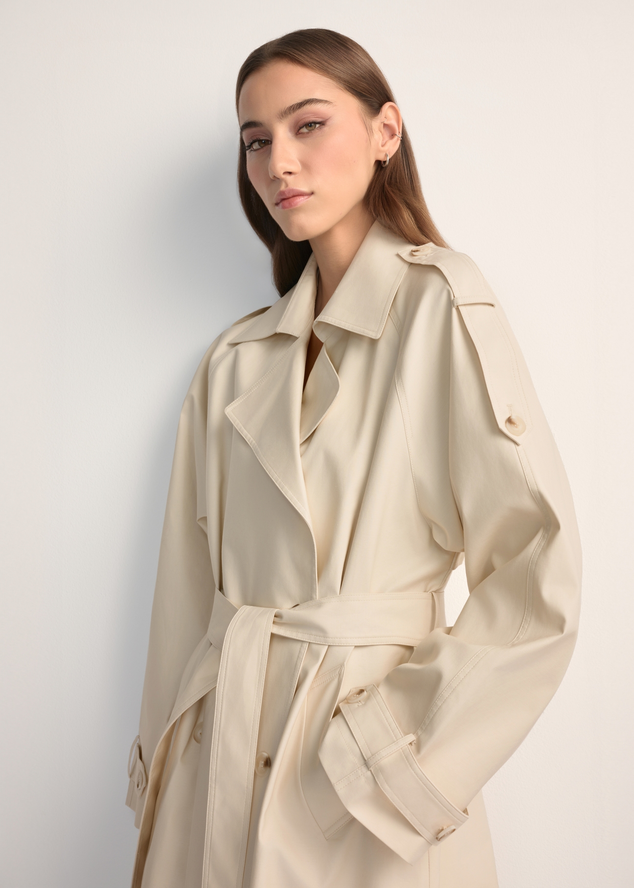 Long cream oversize women's coat KURDT-0659-0C(W26), front view of the product on the model. Half of the silhouette visible.