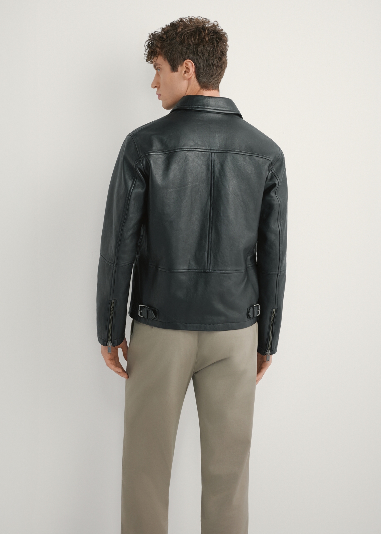 Men's black leather jacket KURMS-0363-99(W26), product view from the back on the model. Half of the silhouette visible.